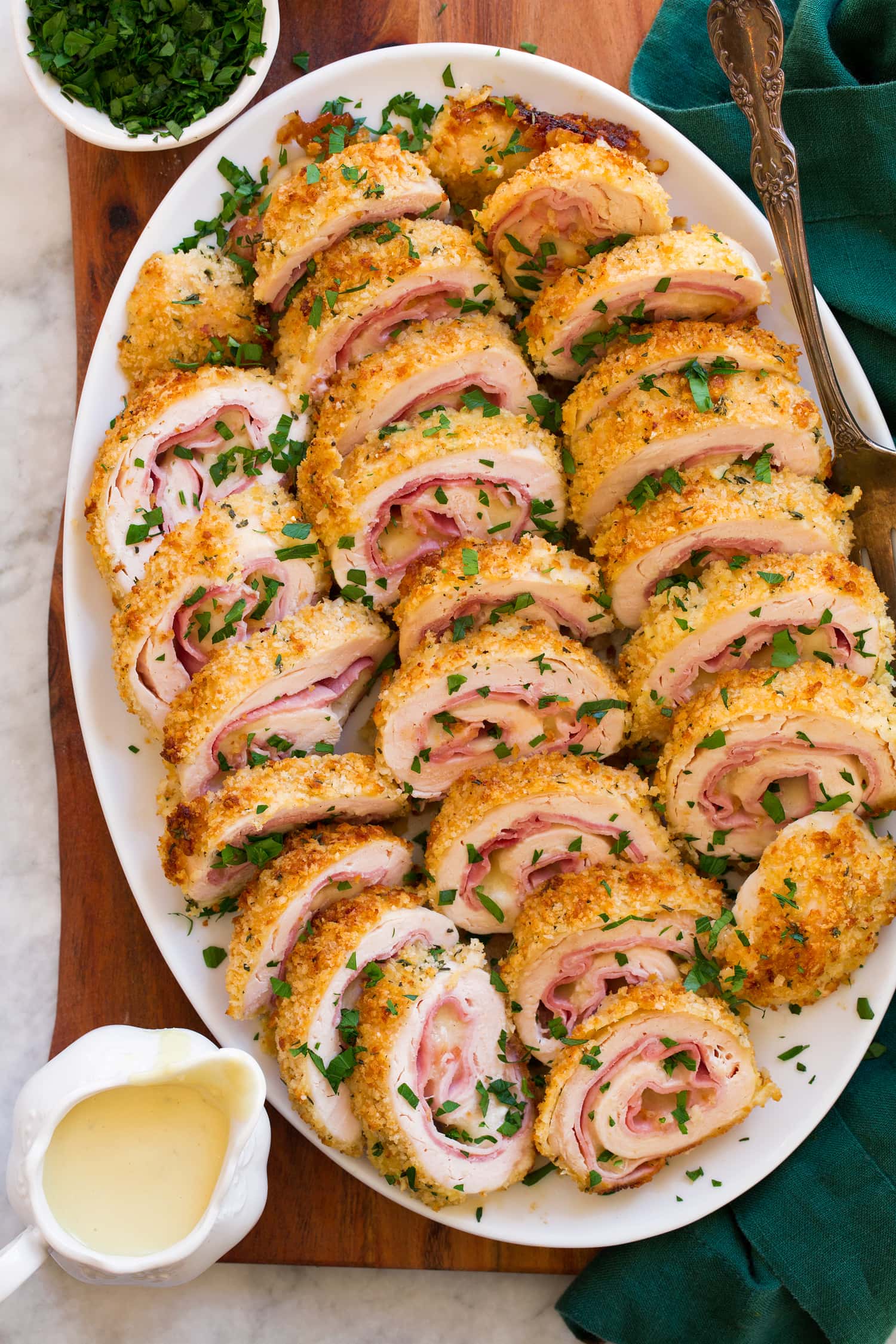Chicken Cordon Bleu Chicken Cordon Bleu cut into slices and shown an a white oval serving tray.