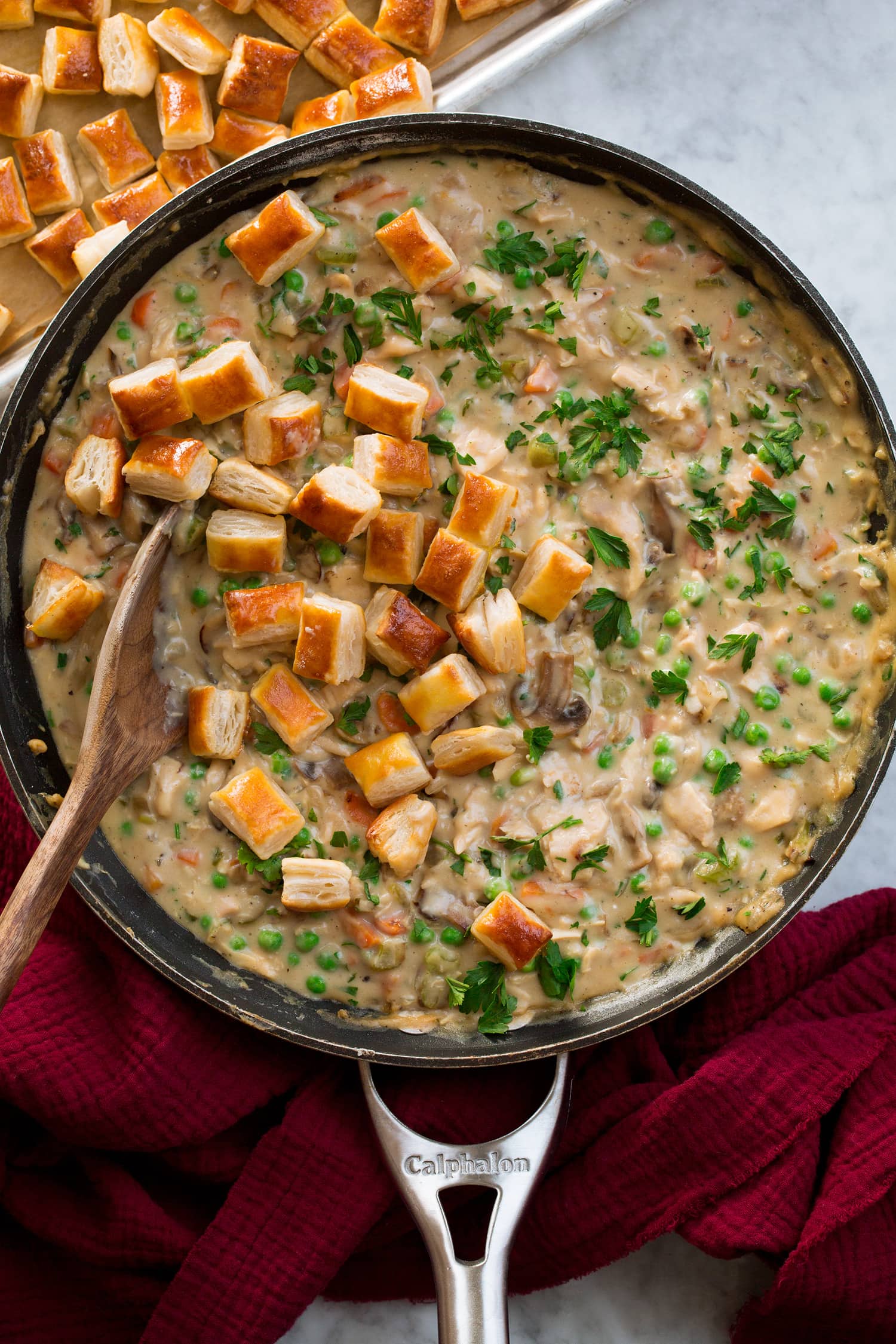 Chicken Pot Pie with Puff Pastry Chicken pot pie in a skillet with golden brown baked puff pastry pieces.