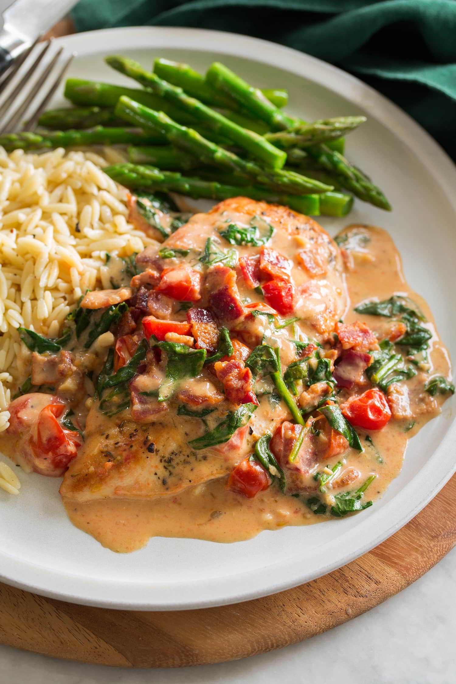 BLT Chicken Smothered chicken served with orzo and asparagus.