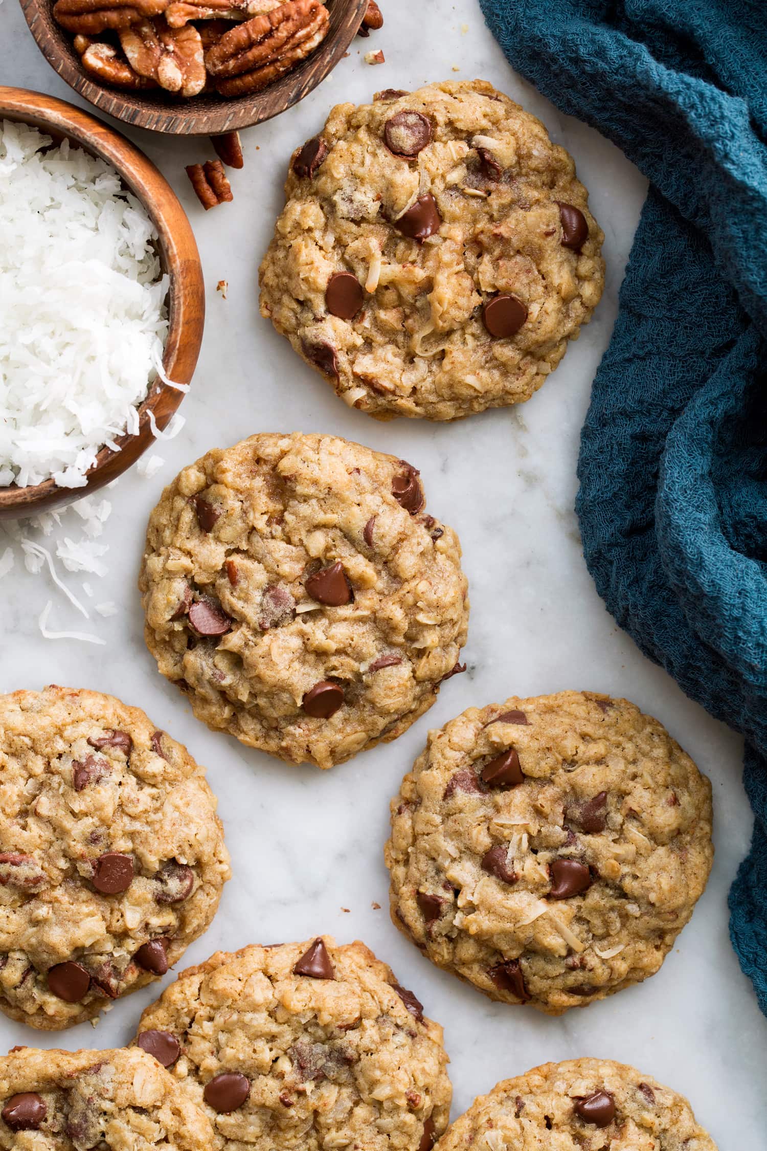 Cowboy Cookies Close up overhead photo of cowboy cookies with coconut and pecans to the side.