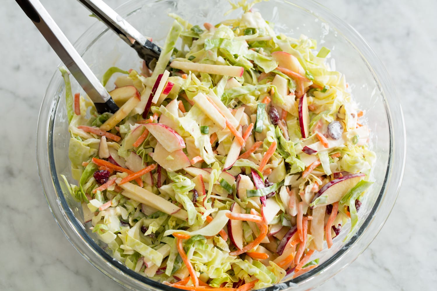 Apple Slaw Finished apple slaw in large glass bowl.