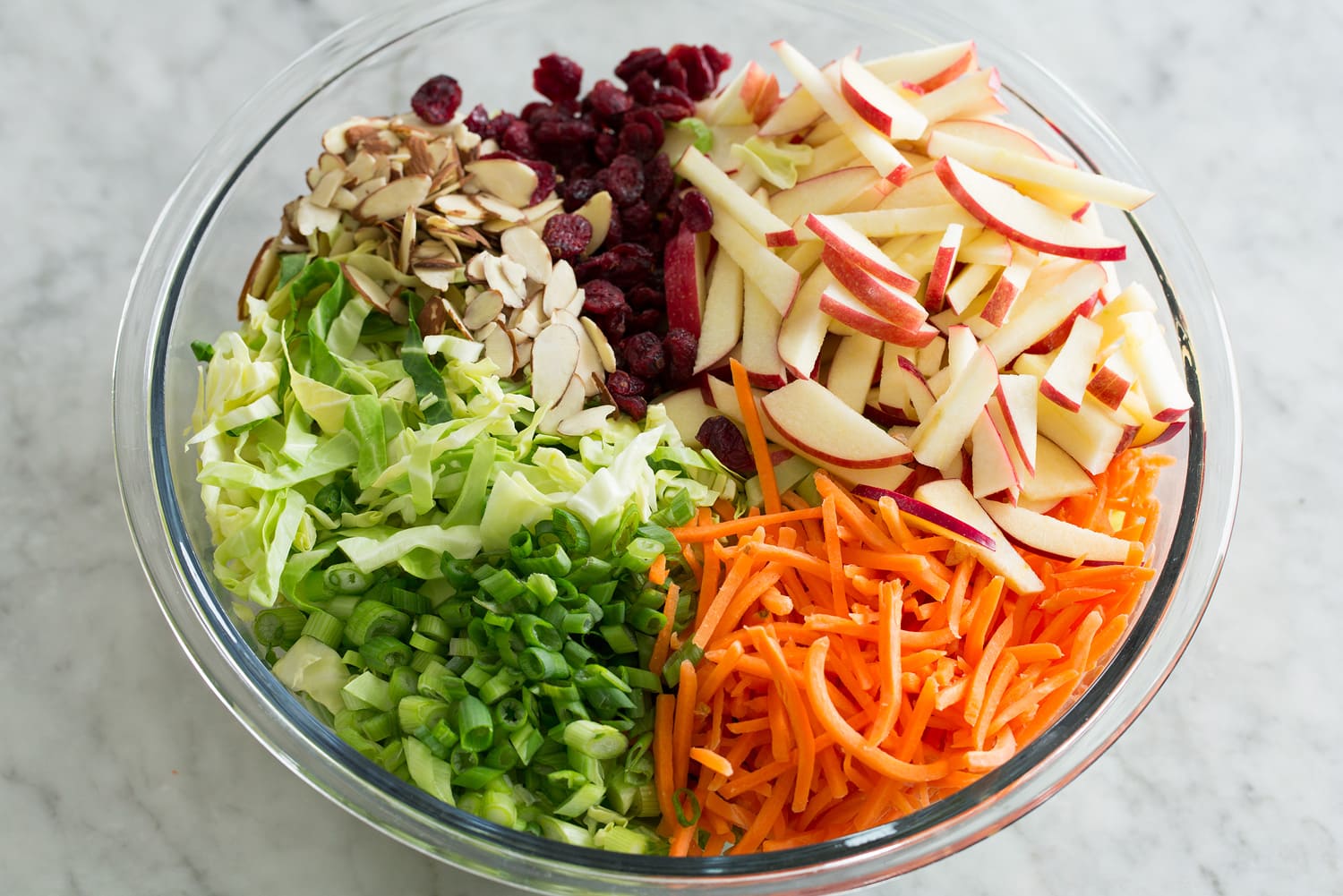 Apple Slaw Apple slaw salad ingredients in bowl before mixing.