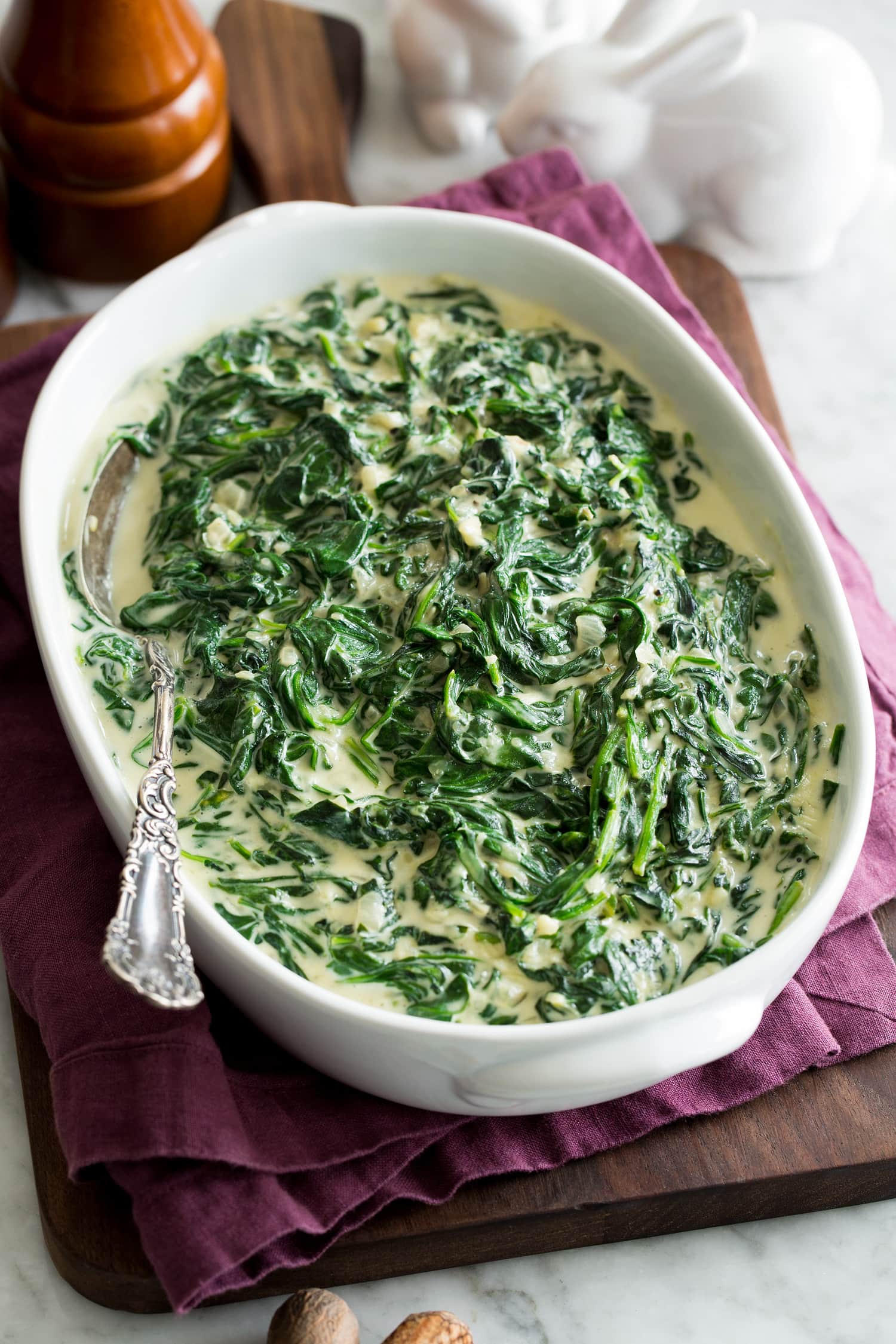 Creamed Spinach Homemade creamed spinach in a white oval serving dish.