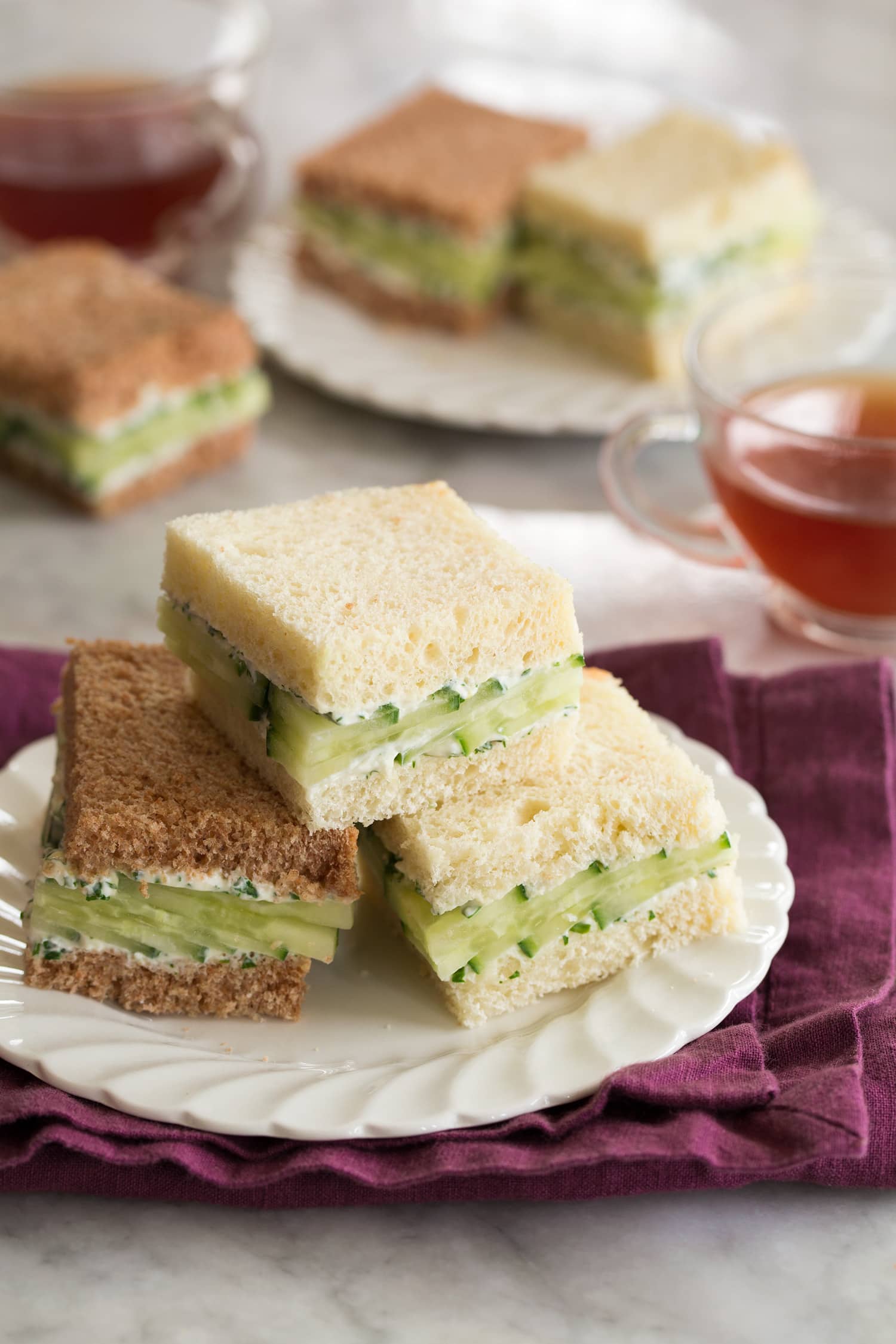 Cucumber Sandwiches Tea plate with cucumber sandwiches and tea served to the side.