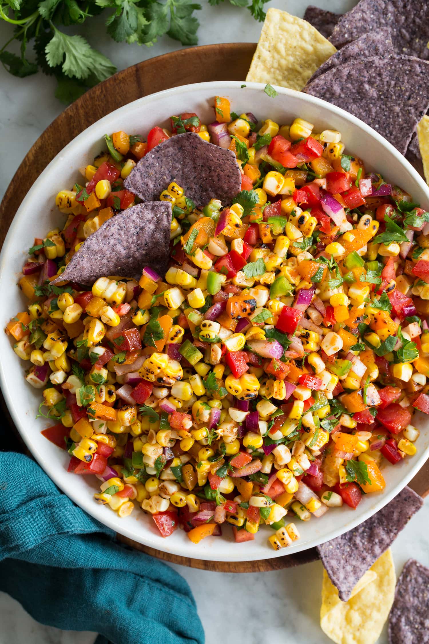 Corn Salsa Overhead photo of corn salsa with tortilla chips dipped in.