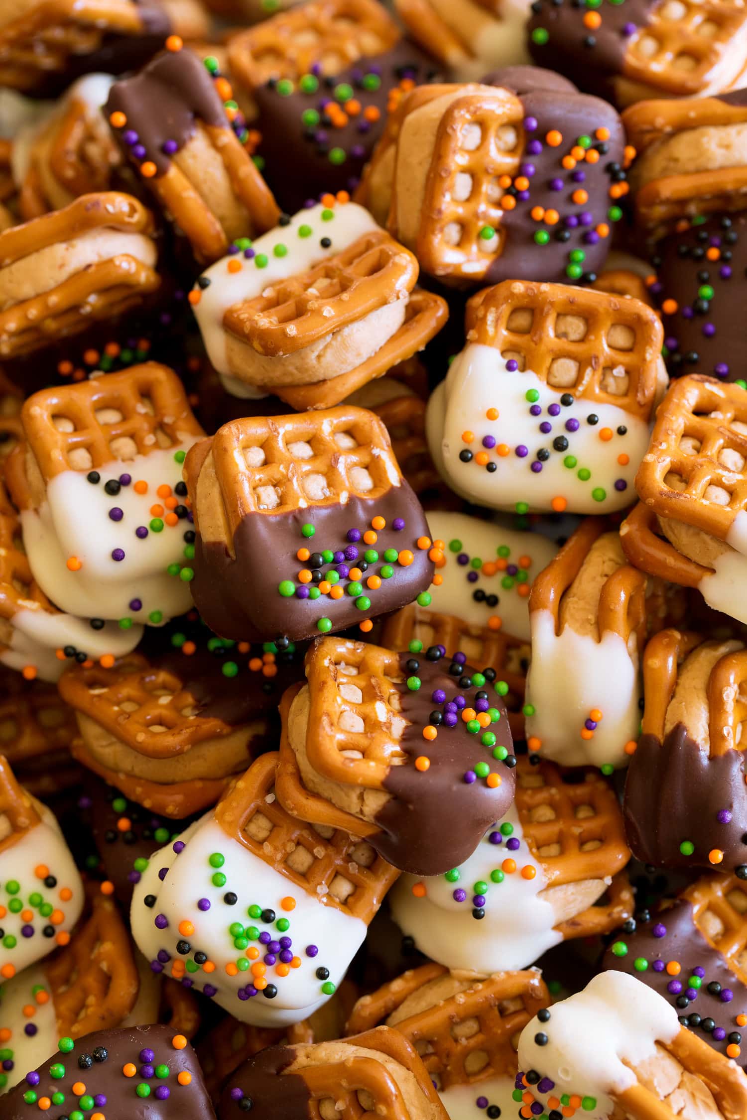 Chocolate Covered Peanut Butter Pretzel Bites Close up photo of pretzels stuffed with peanut butter filing and coated with chocolate and sprinkes.
