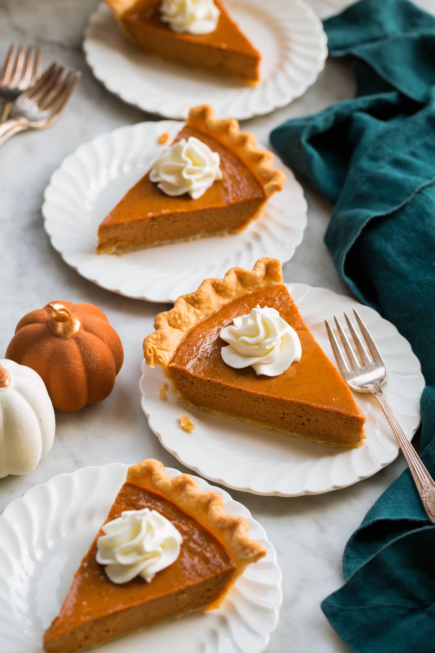 Easy Pumpkin Pie Four slices of pumpkin pie with whipped cream.
