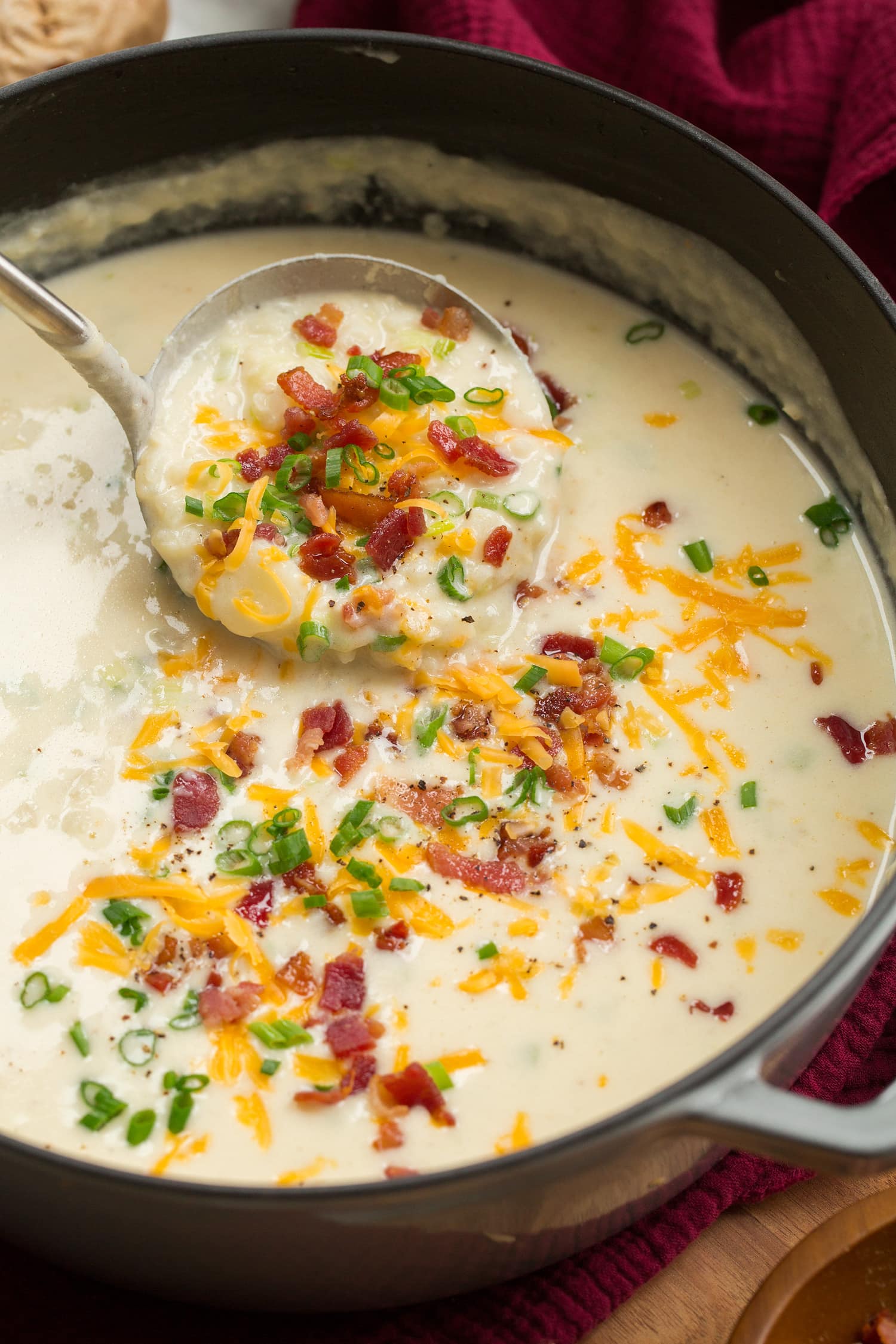 Baked Potato Soup Pot full of baked potato soup with a ladle scooping out.