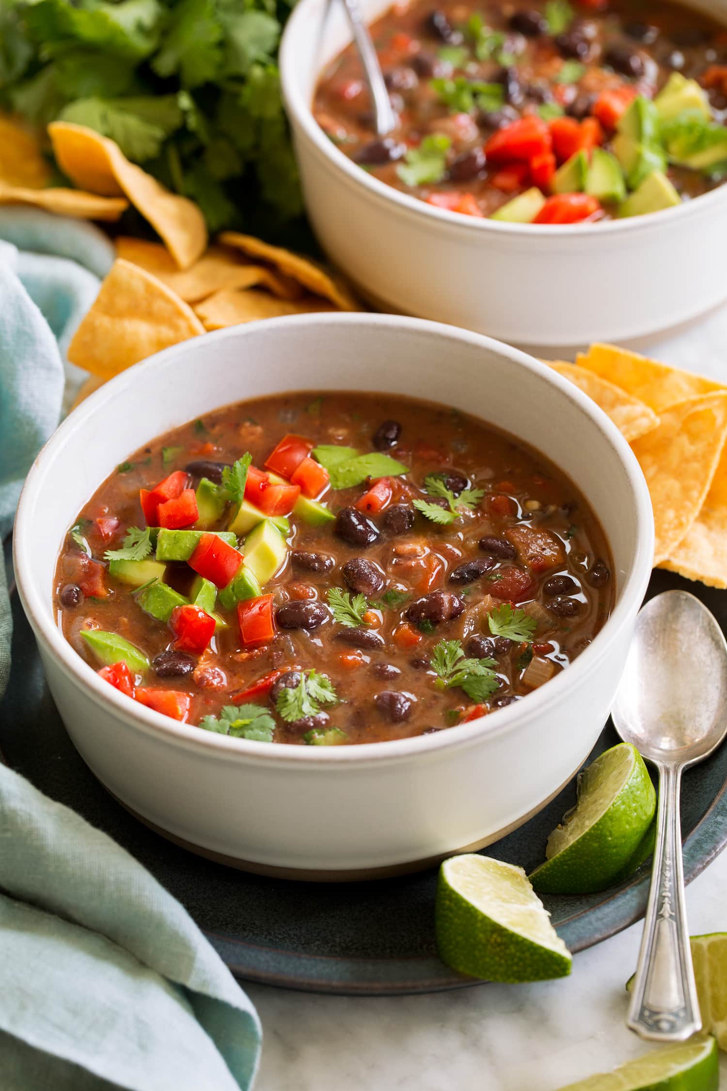Black Bean Soup Serving of homemade black bean soup topped with tomatoes, avocado and cilantro.
