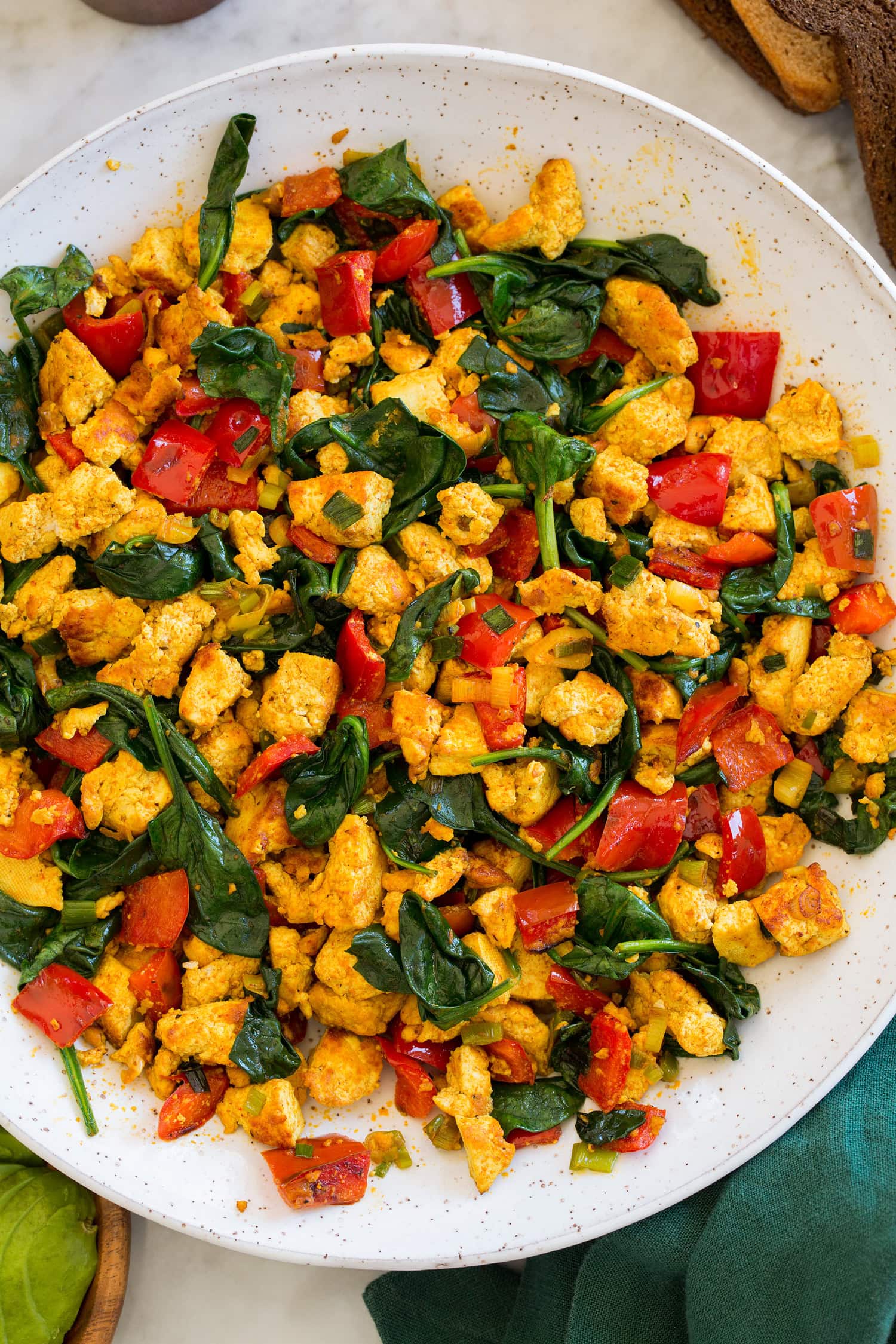 Tofu Scramble Close up overhead photo of tofu scramble with spinach and bell peppers.