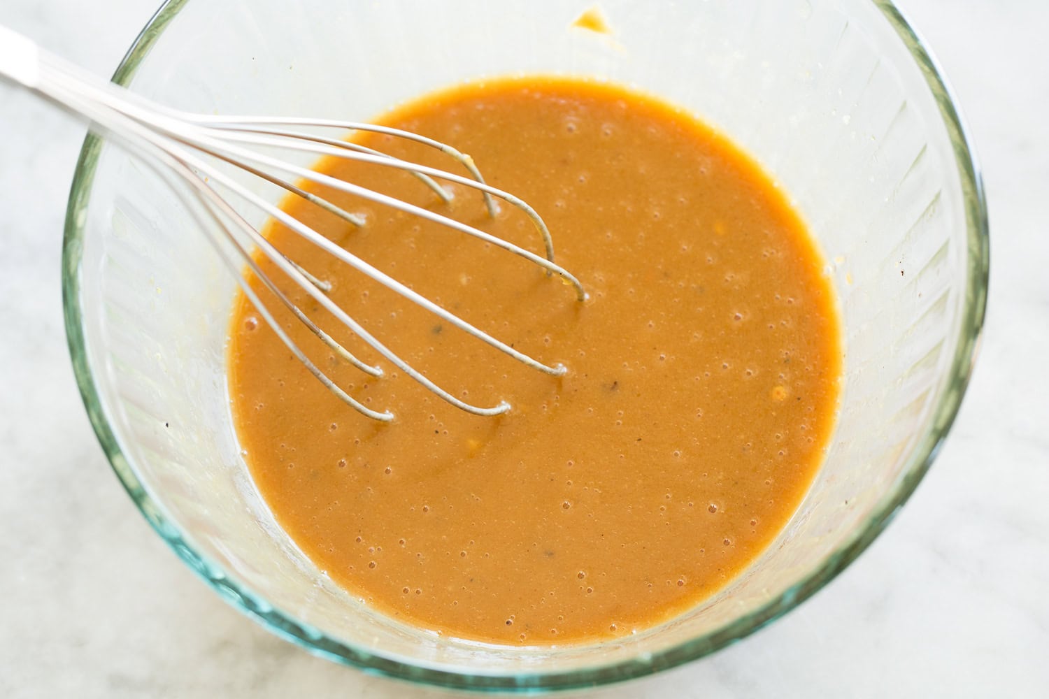 Chinese Chicken Salad Dressing in glass mixing bowl shown after mixing.