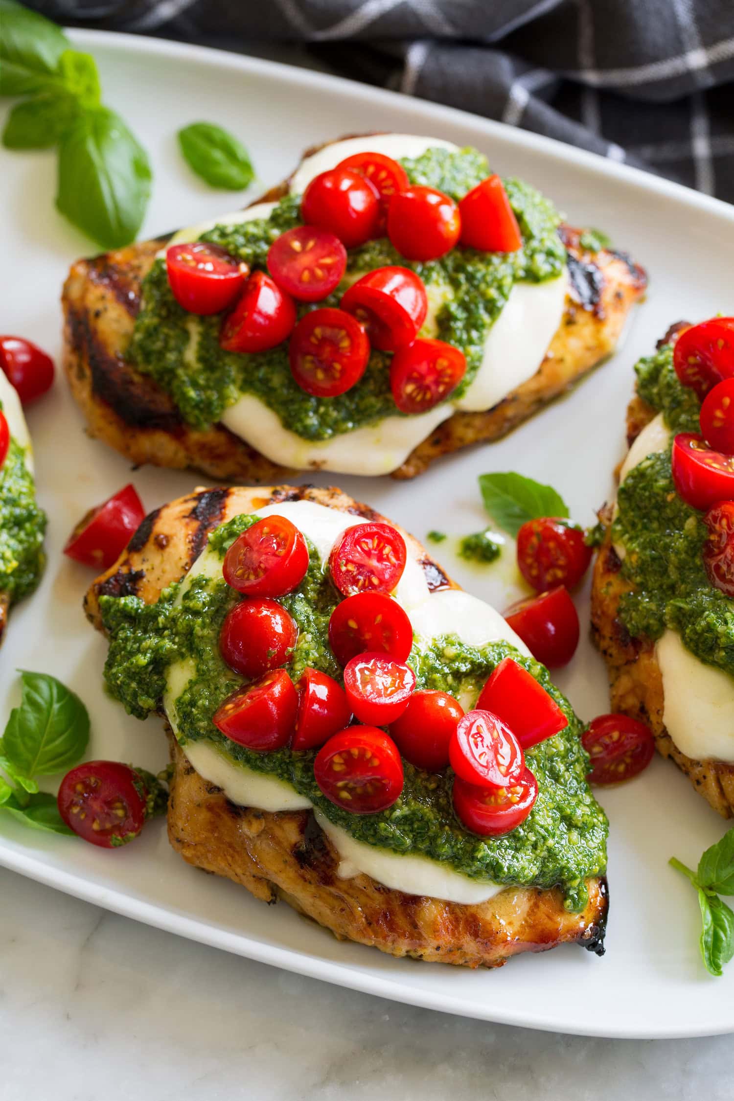 Grilled Chicken Margherita Grilled chicken margherita made with grilled chicken breasts, homemade pesto, fresh mozzarella and grape tomatoes.