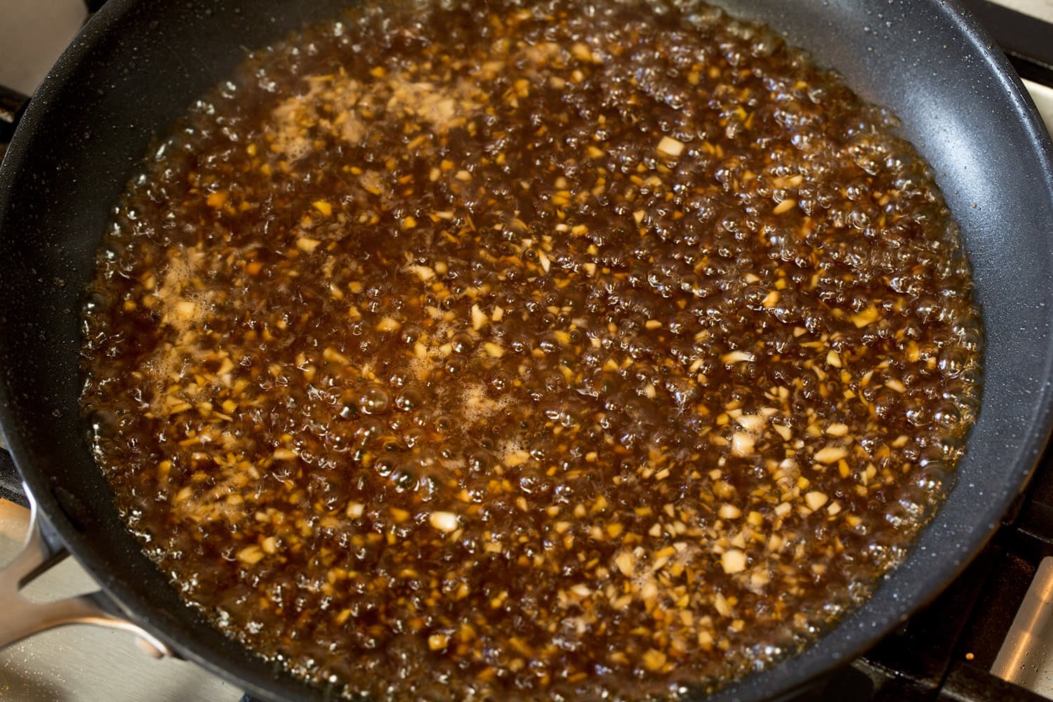 Teriyaki sauce simmering in skillet.