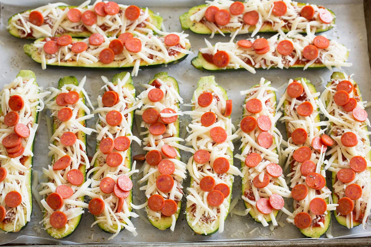 Zucchini Pizza Boats Raw fully prepared zucchini boats before cooking.