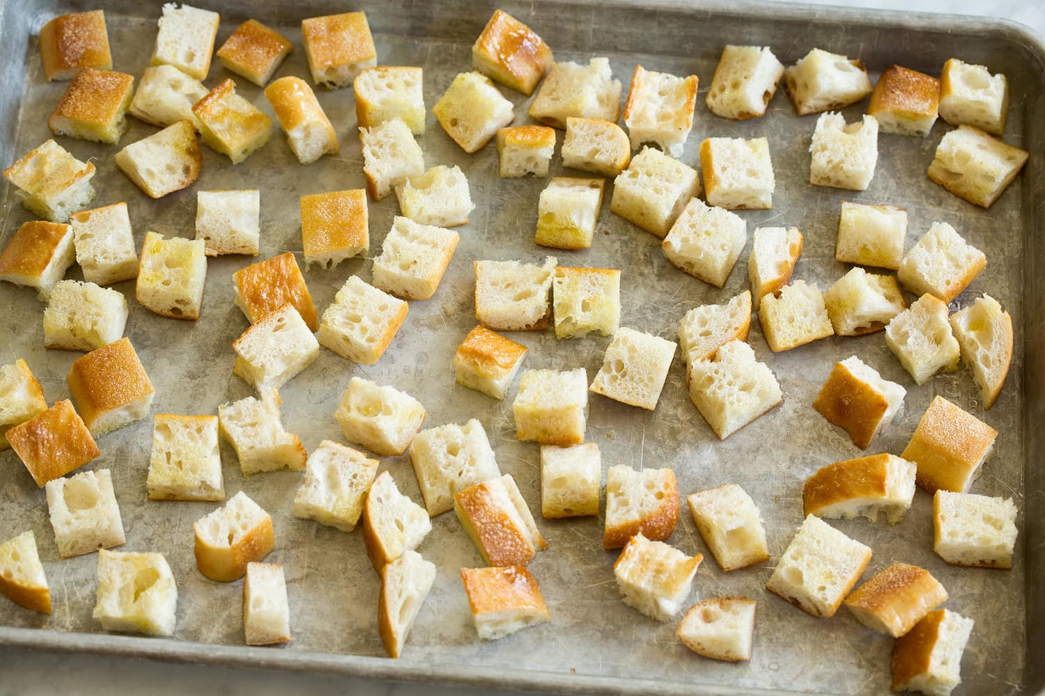 Panzanella Salad Bread cubes on a baking sheet before toasting in the oven.