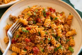 Serving of taco pasta in a pasta bowl with a fork.