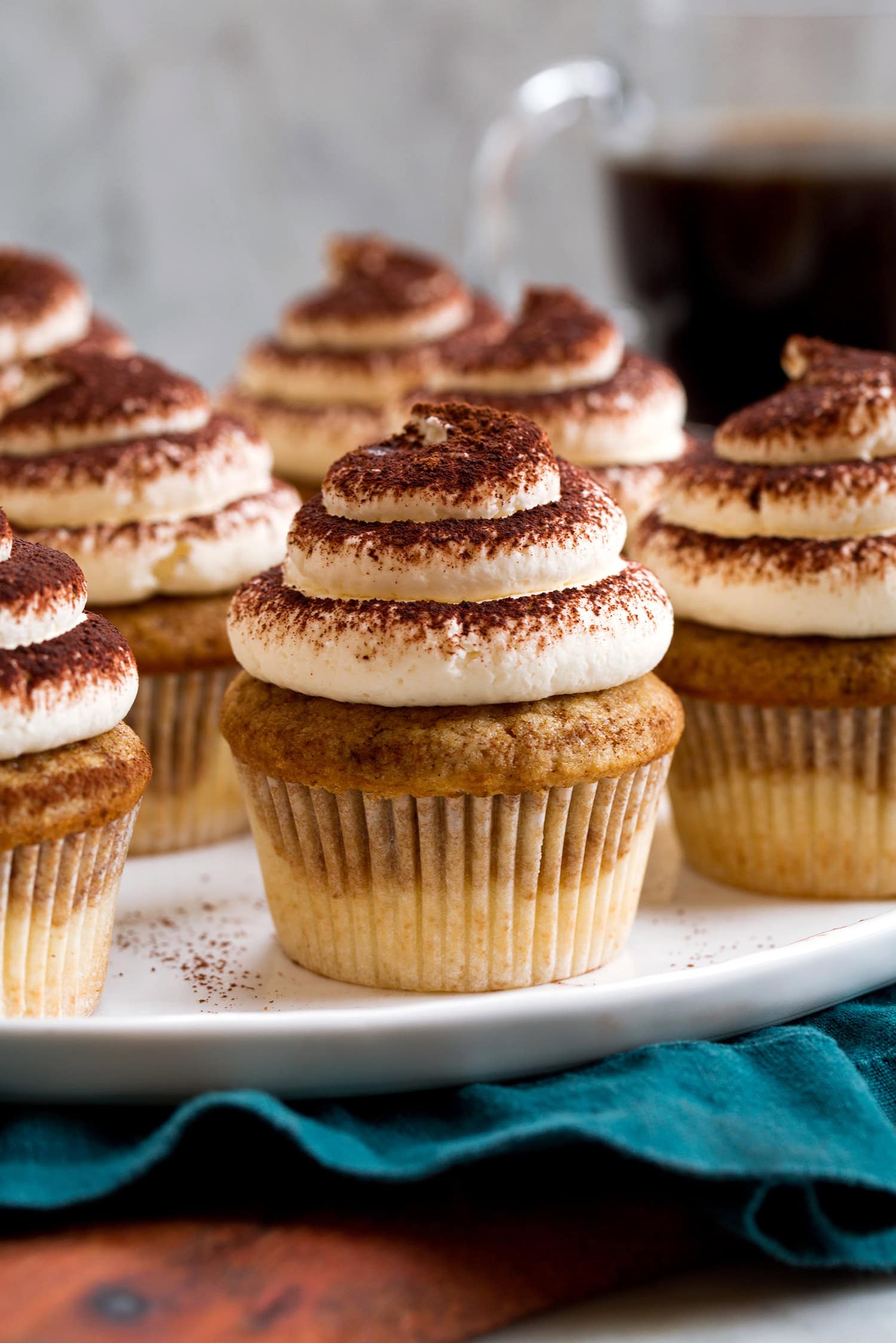 Tiramisu Cupcakes Close up photo of tiramisu cupcakes with mascarpone frosting dusted with cocoa and coffee vanilla cupcake.