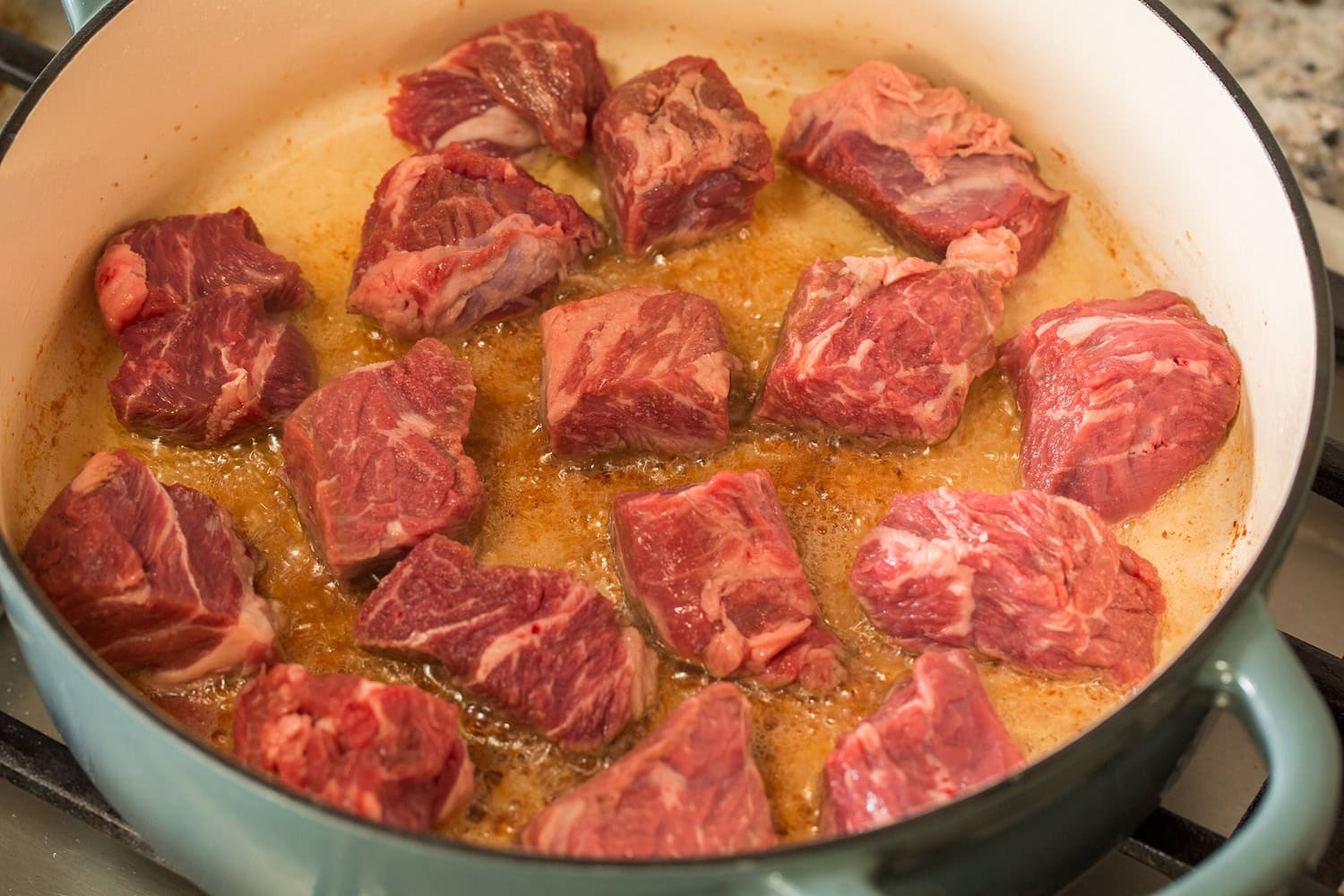 Beef Bourguignon Beef chuck chunks shown before searing in a pot.