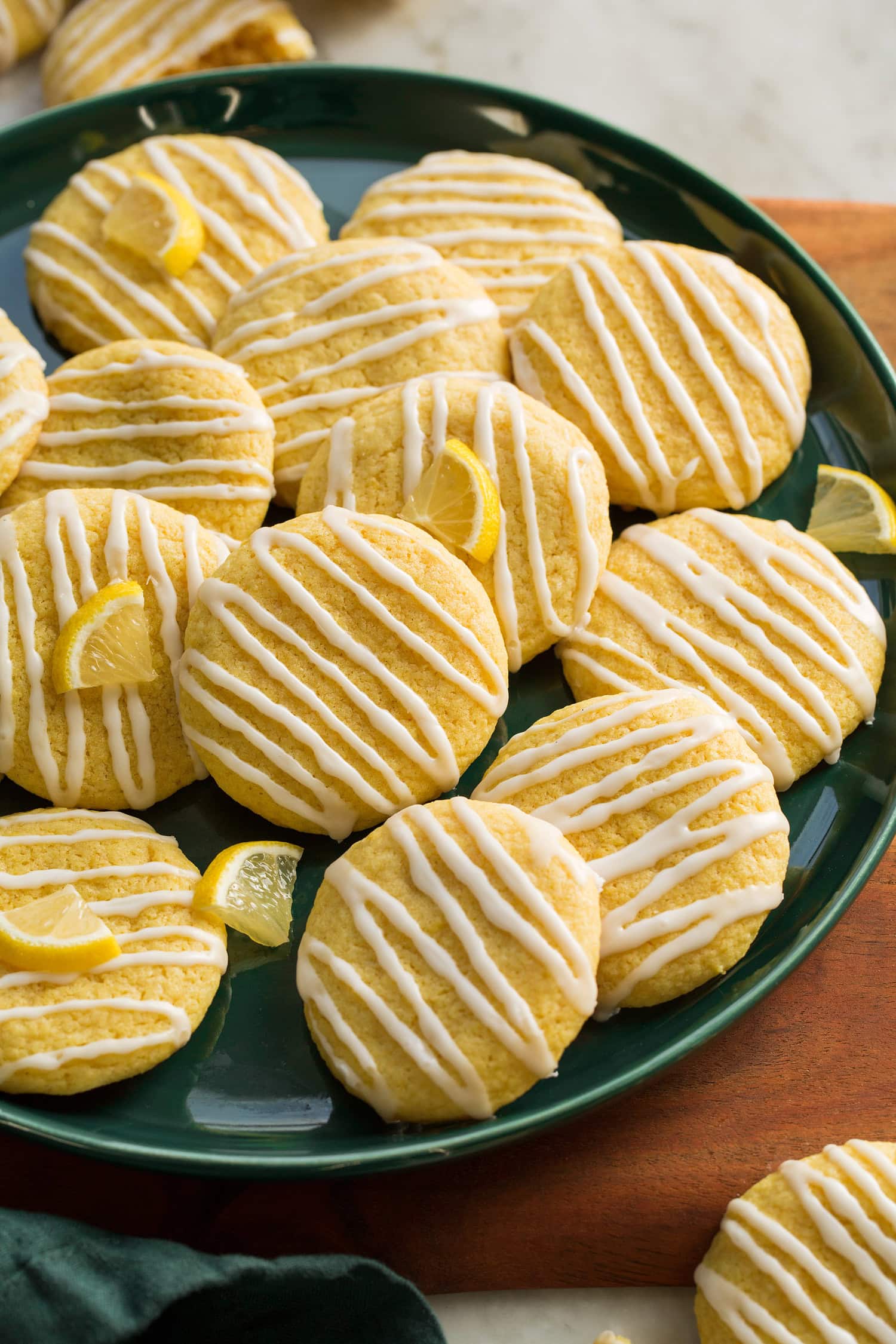 Lemon Cookies Close up photo of soft lemon cookies with zigzags of glaze atop.