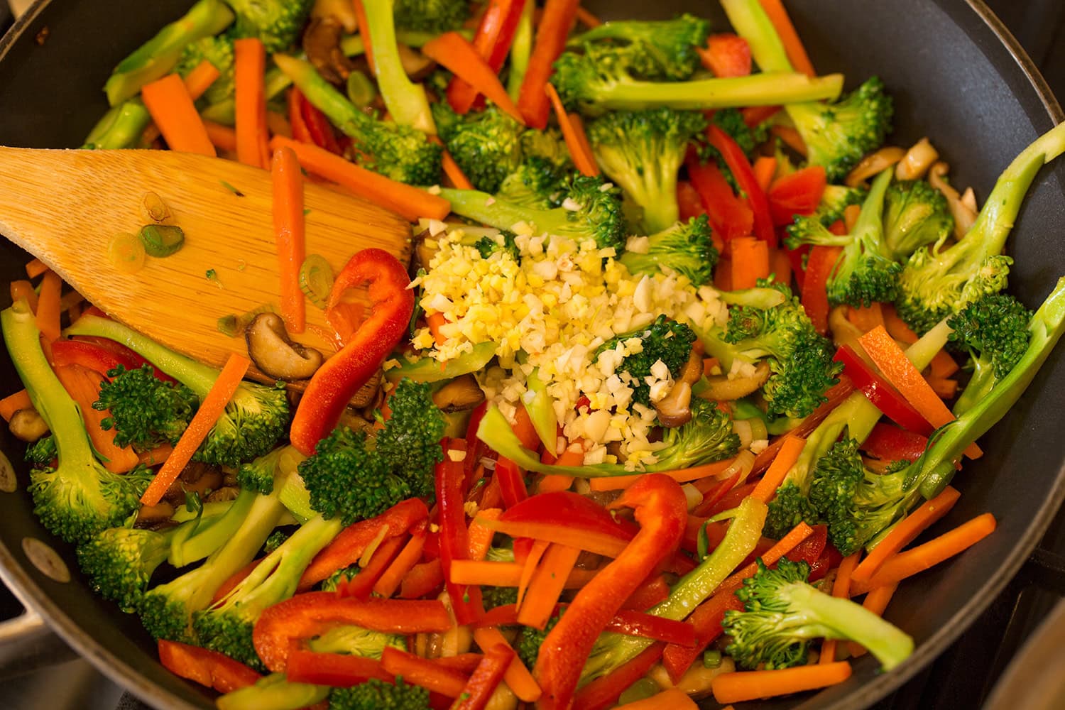 Broccoli, carrots, bell peppers, garlic and ginger sautéing.
