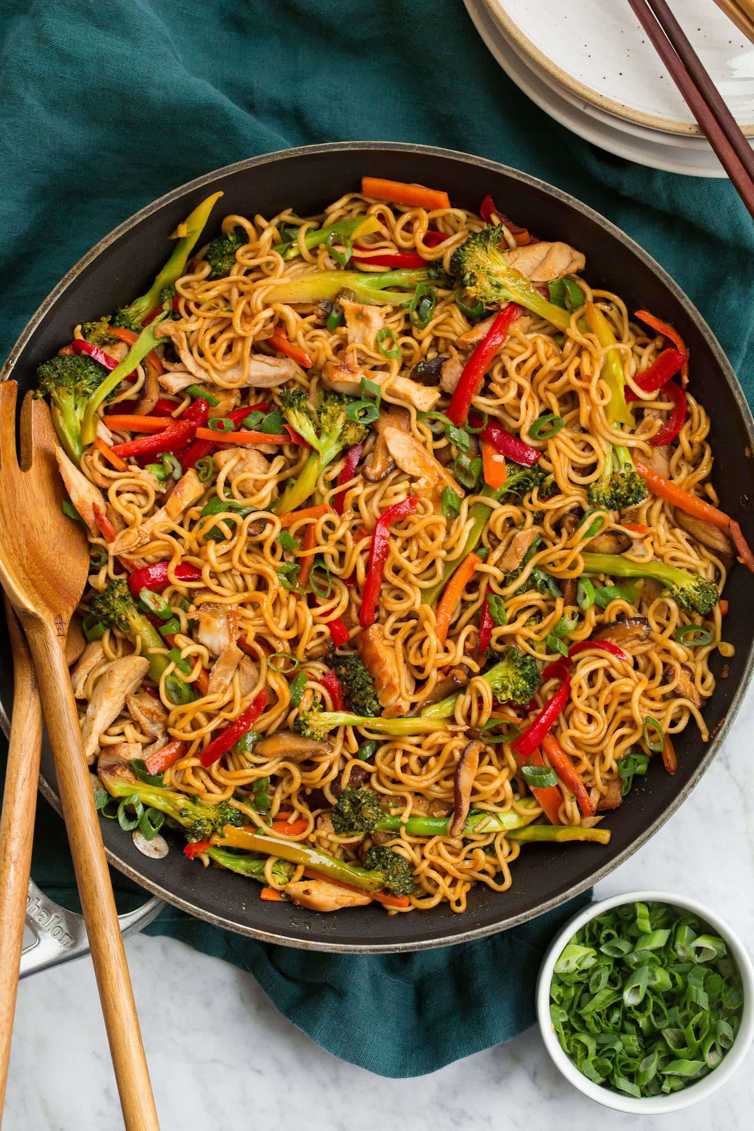Overhead photo of stir fry noodles with chicken in a large skillet.