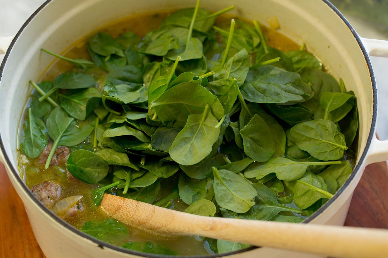 Italian Wedding Soup Spinach added to soup.