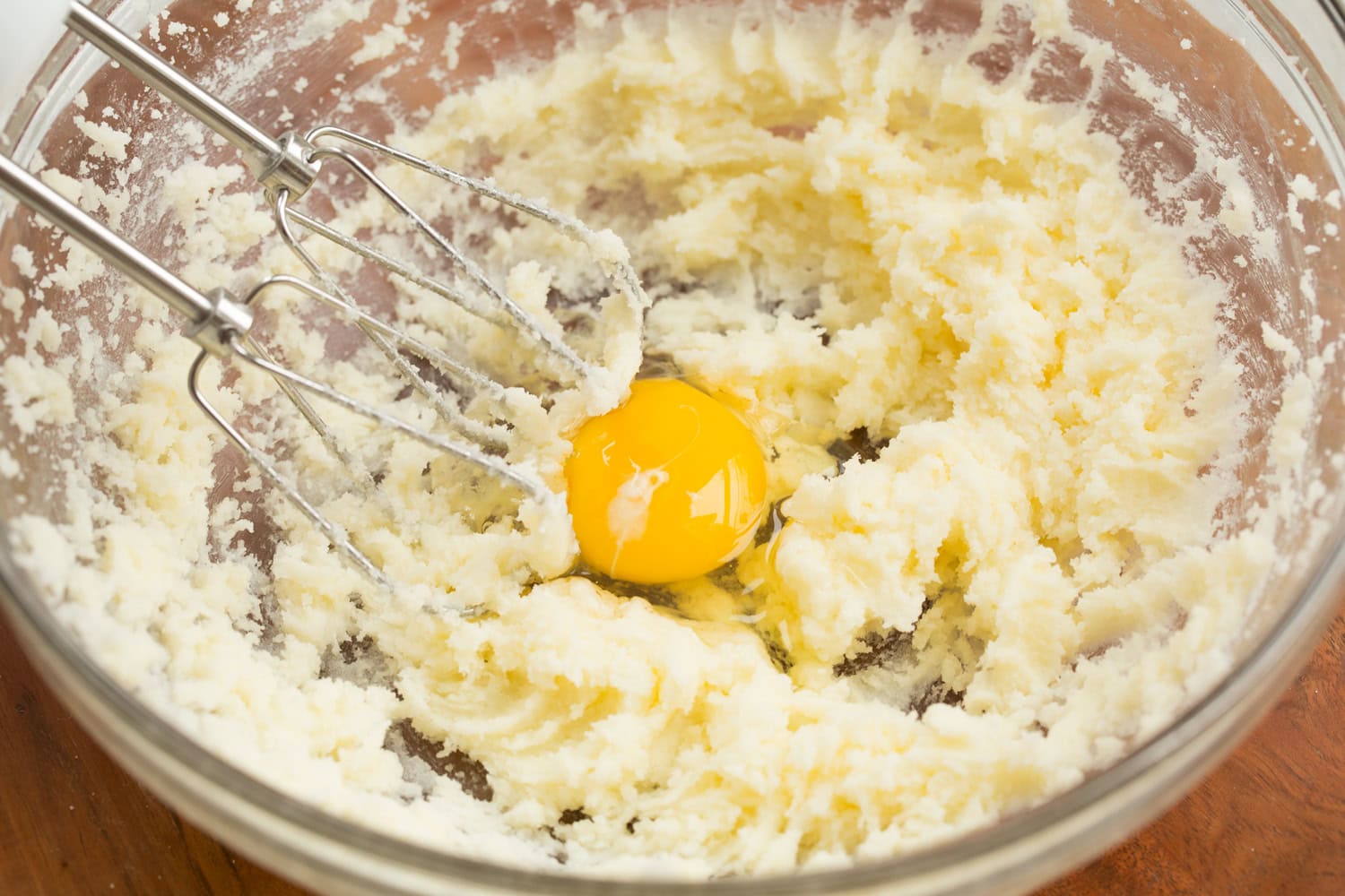 Tiramisu Cupcakes Adding egg to cupcake batter.