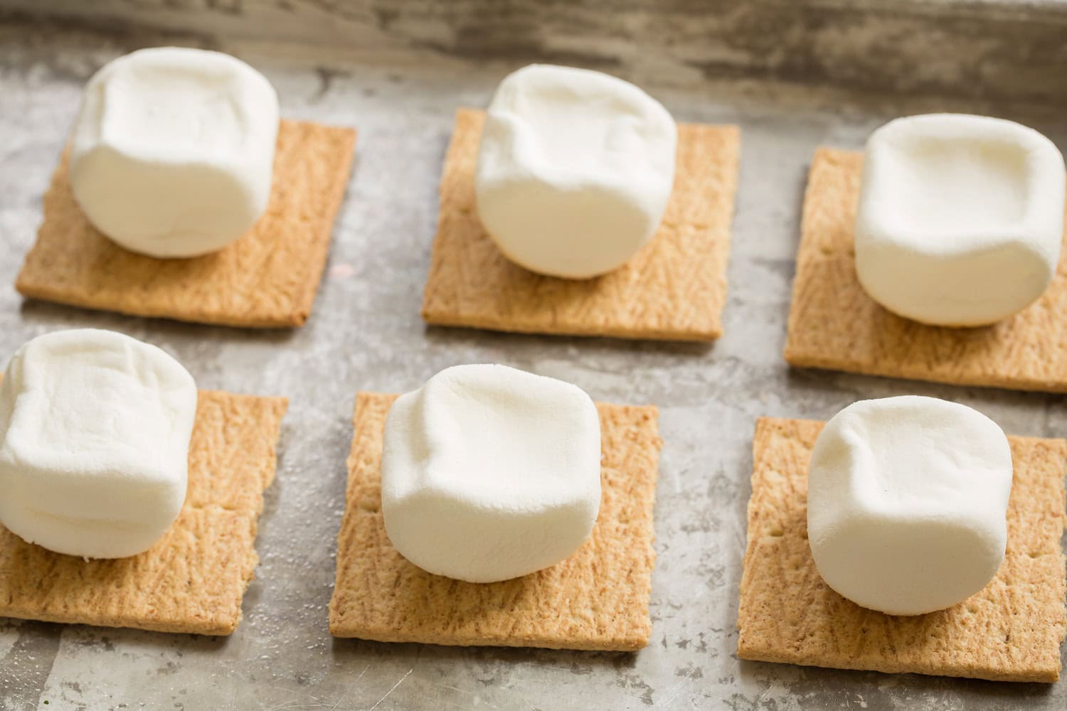 Oven S'mores Marhsmallows turned over to untoasted side and set on a graham cracker to toast under broiler on second side.