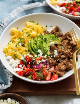 Breakfast bowl made with turkey sausage, scrambled eggs, pico, avocado and feta.