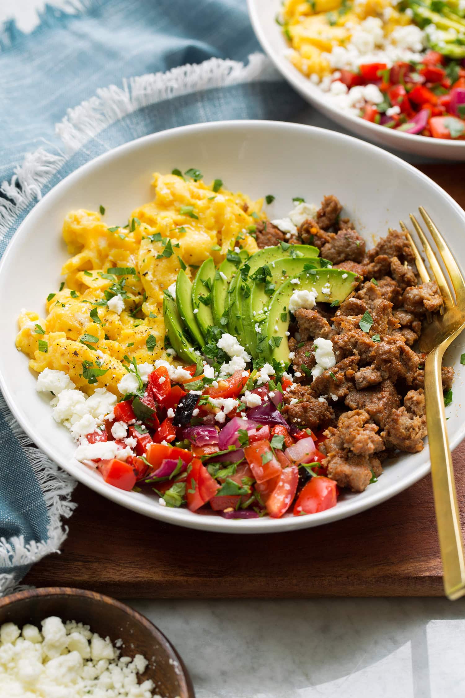 Breakfast Bowls Breakfast bowl made with turkey sausage, scrambled eggs, pico, avocado and feta.