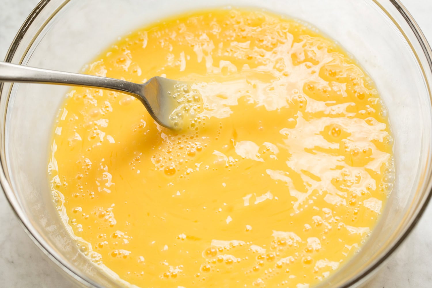 Breakfast Bowls Eggs in a bowl shown scrambled with a fork.