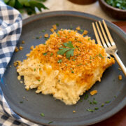 Single serving of funeral potatoes on a blue plate.
