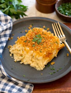 Single serving of funeral potatoes on a blue plate.