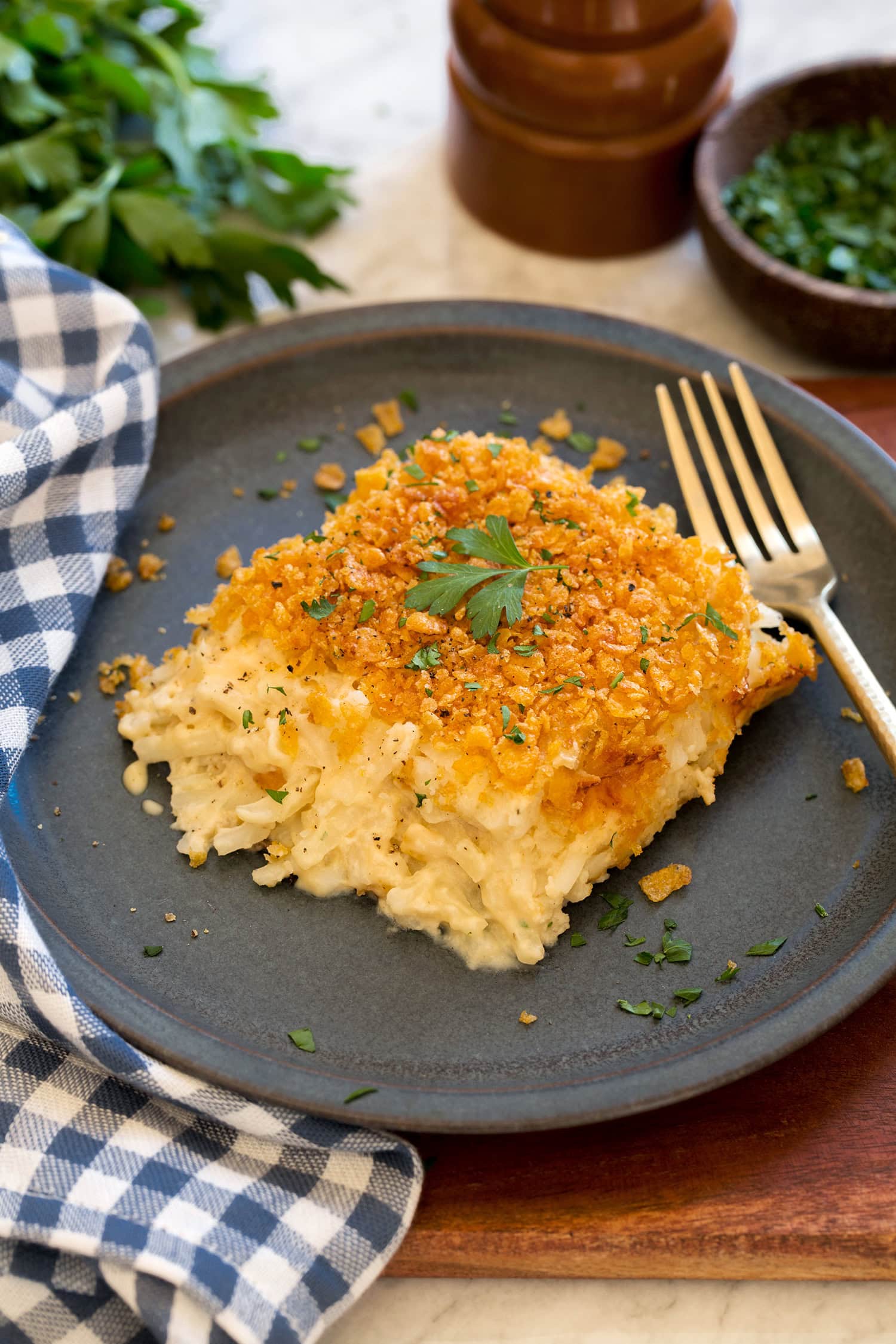 Funeral Potatoes Single serving of funeral potatoes on a blue plate.
