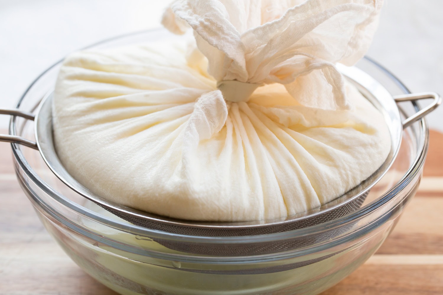 Homemade Yogurt Yogurt straining through cheesecloth.