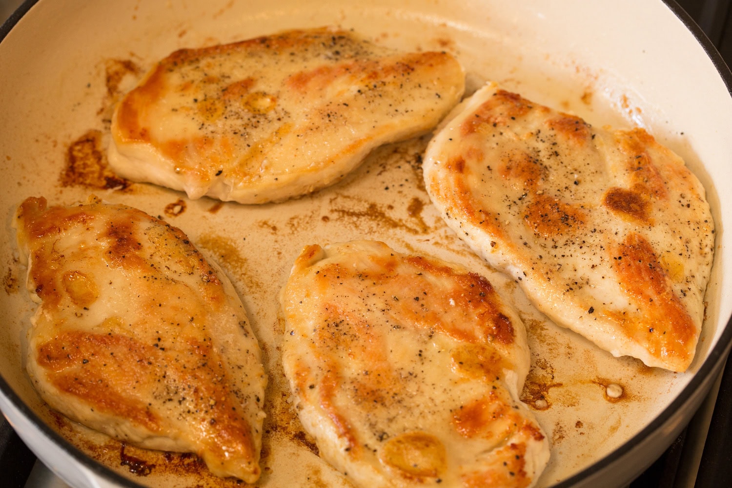 French Onion Chicken Browned chicken breasts in skillet.