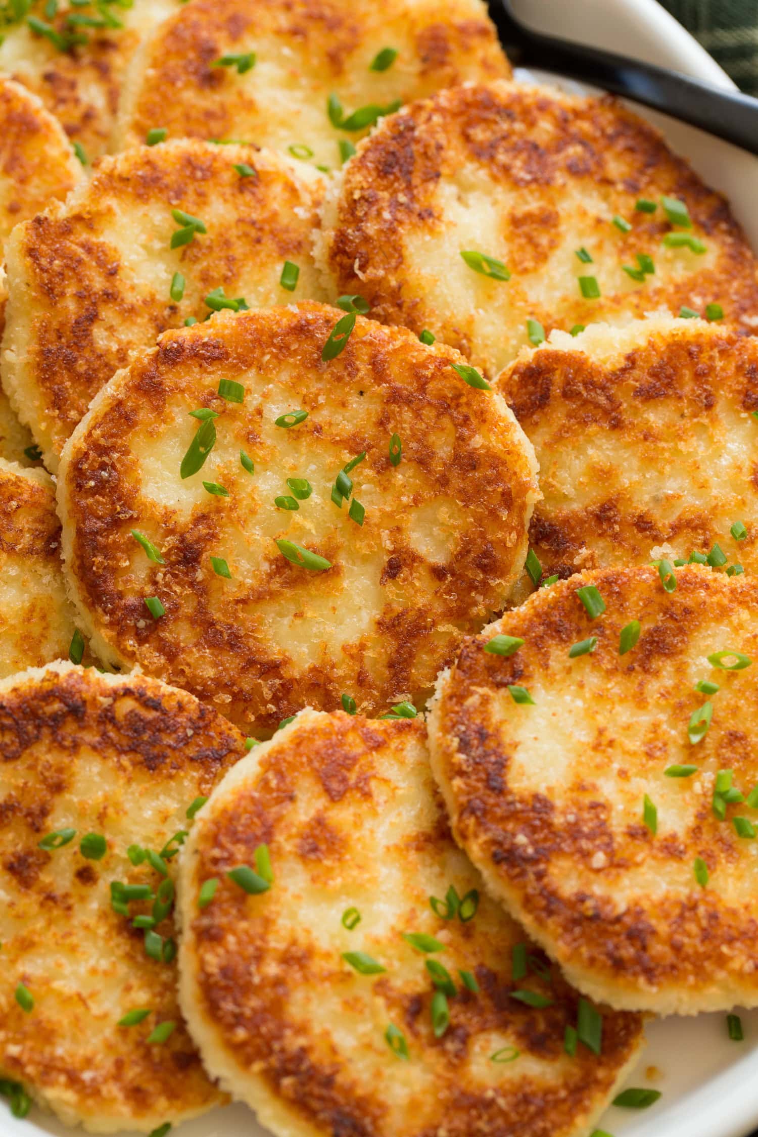 Mashed Potato Cakes Close up photo mashed potato cakes showing panko bread crumbs and browned exterior.
