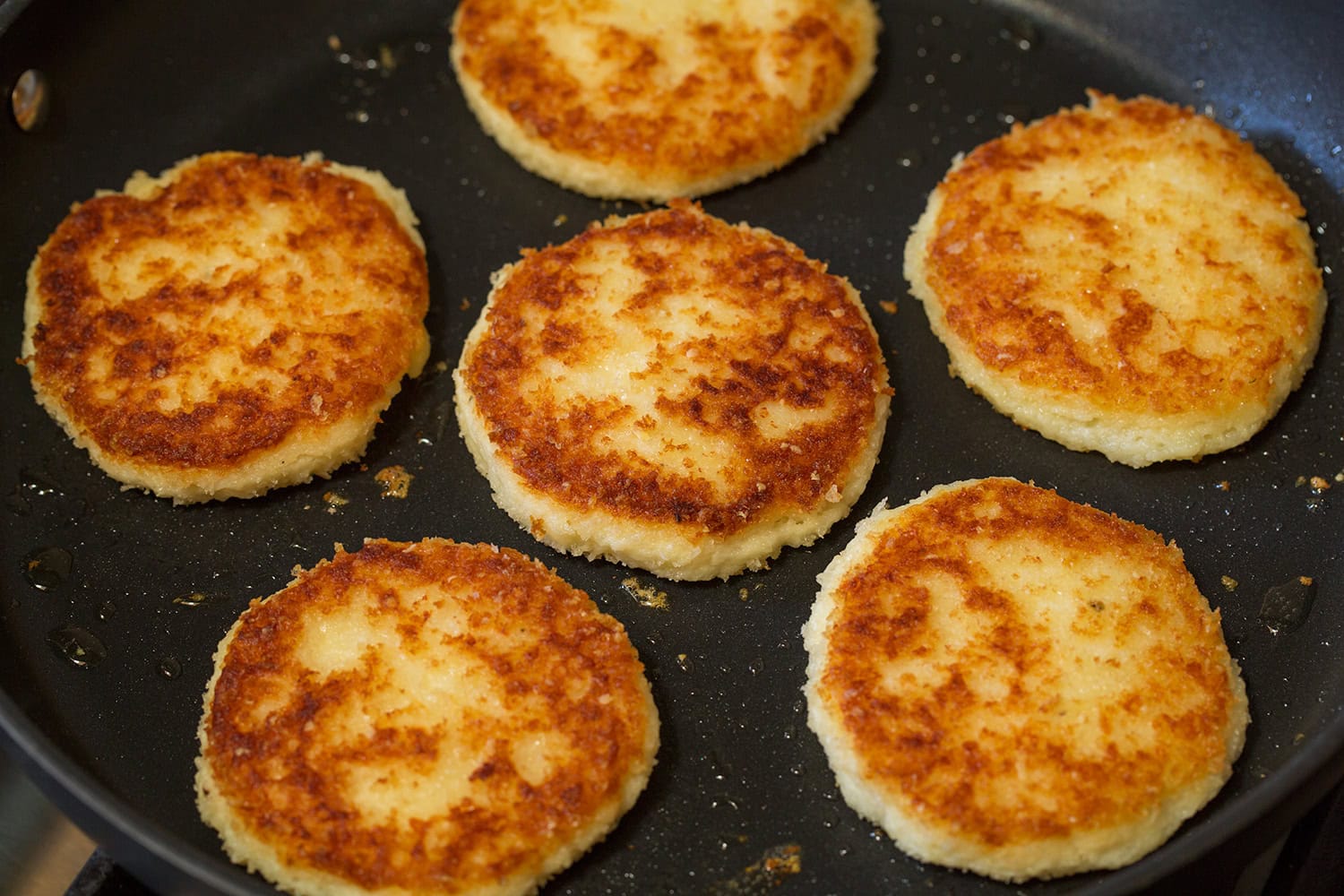 Mashed Potato Cakes Mashed potato cakes shown after being cooked in a skillet and browned.