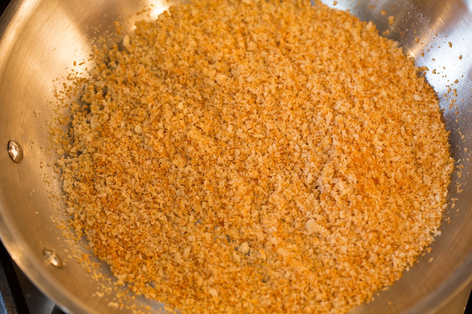 Toasting panko bread crumbs in a skillet.