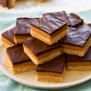 Stacked pyramid of millionaire's shortbread bars.