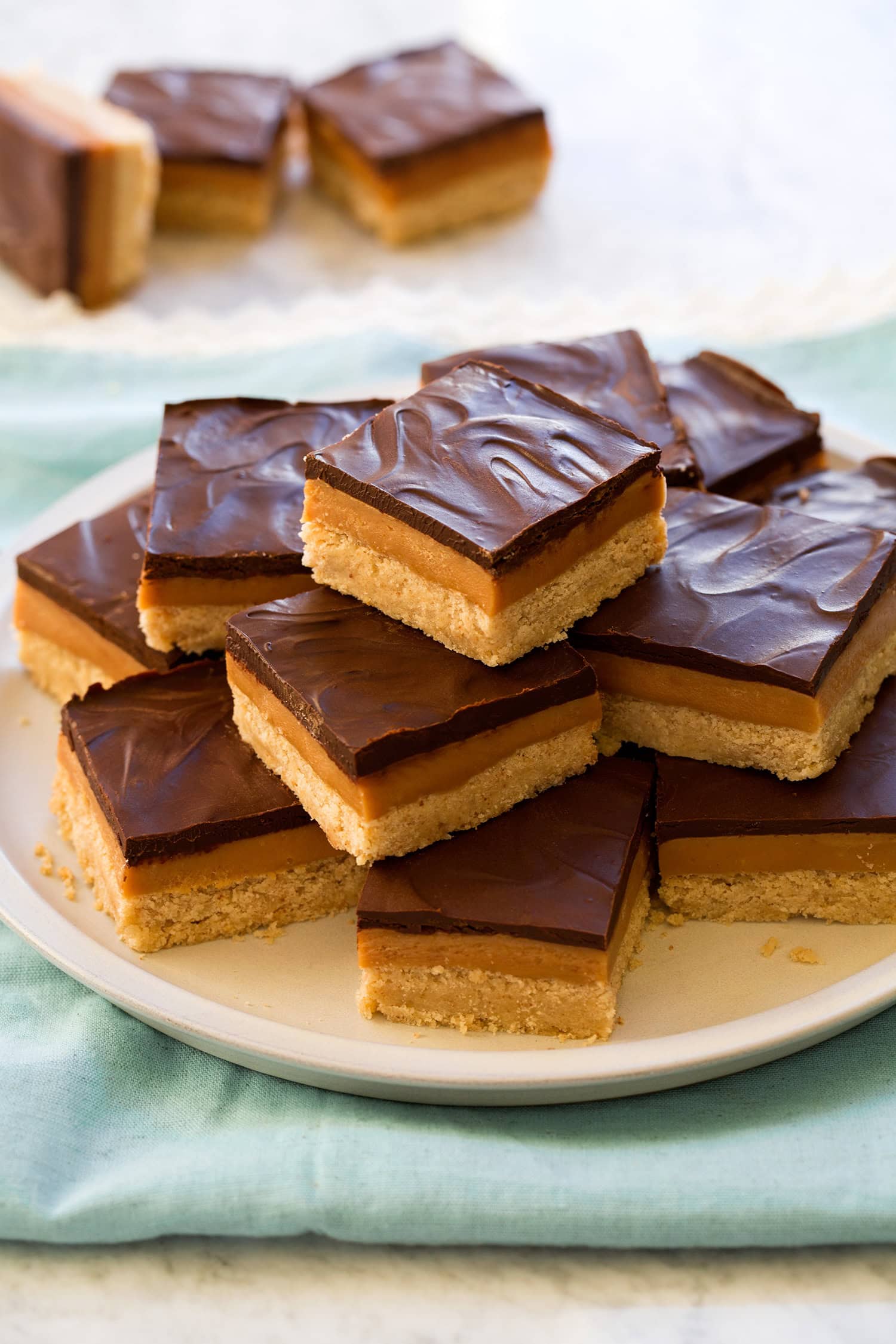Stacked pyramid of millionaire's shortbread bars.