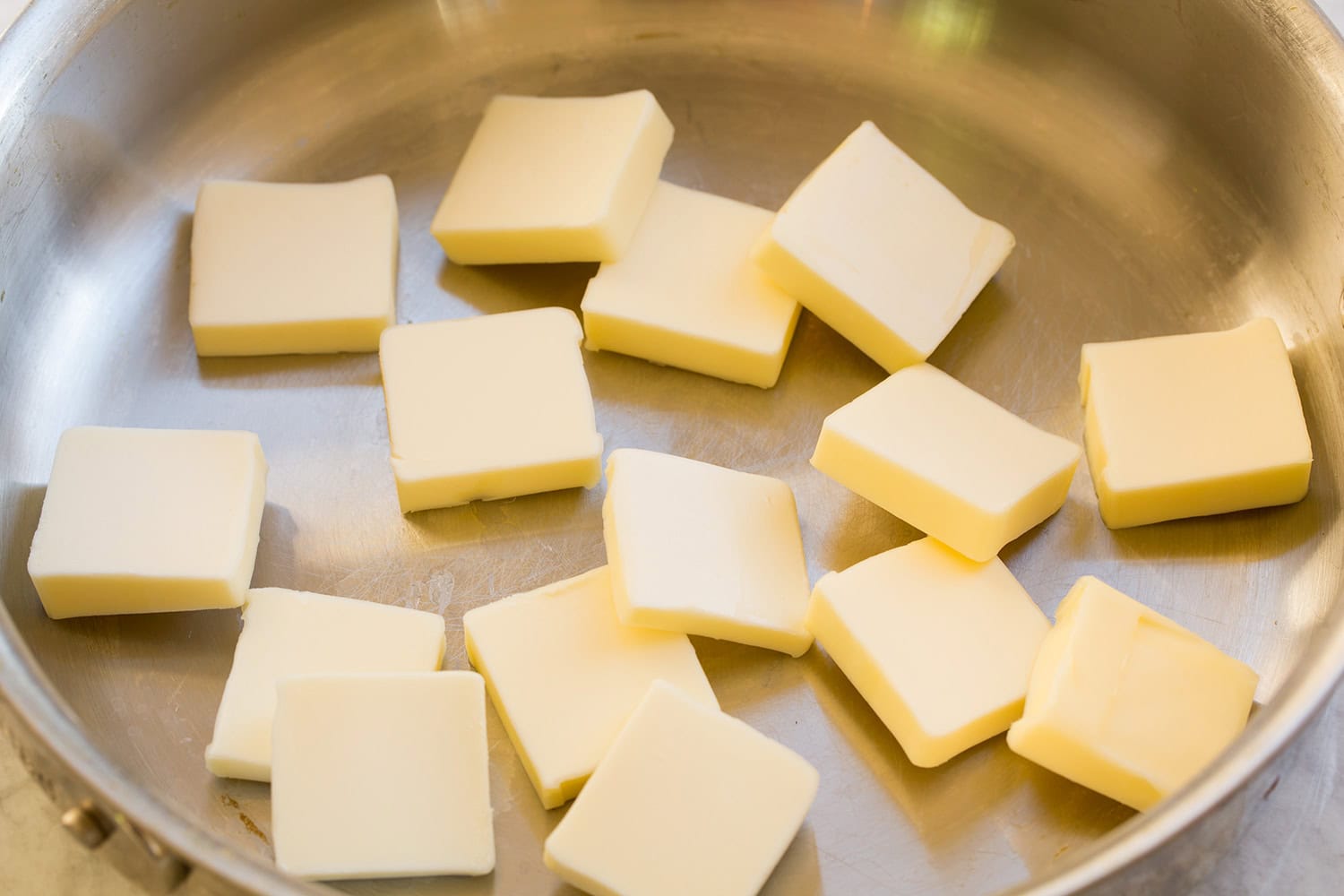 Sliced butter in a saute pan.