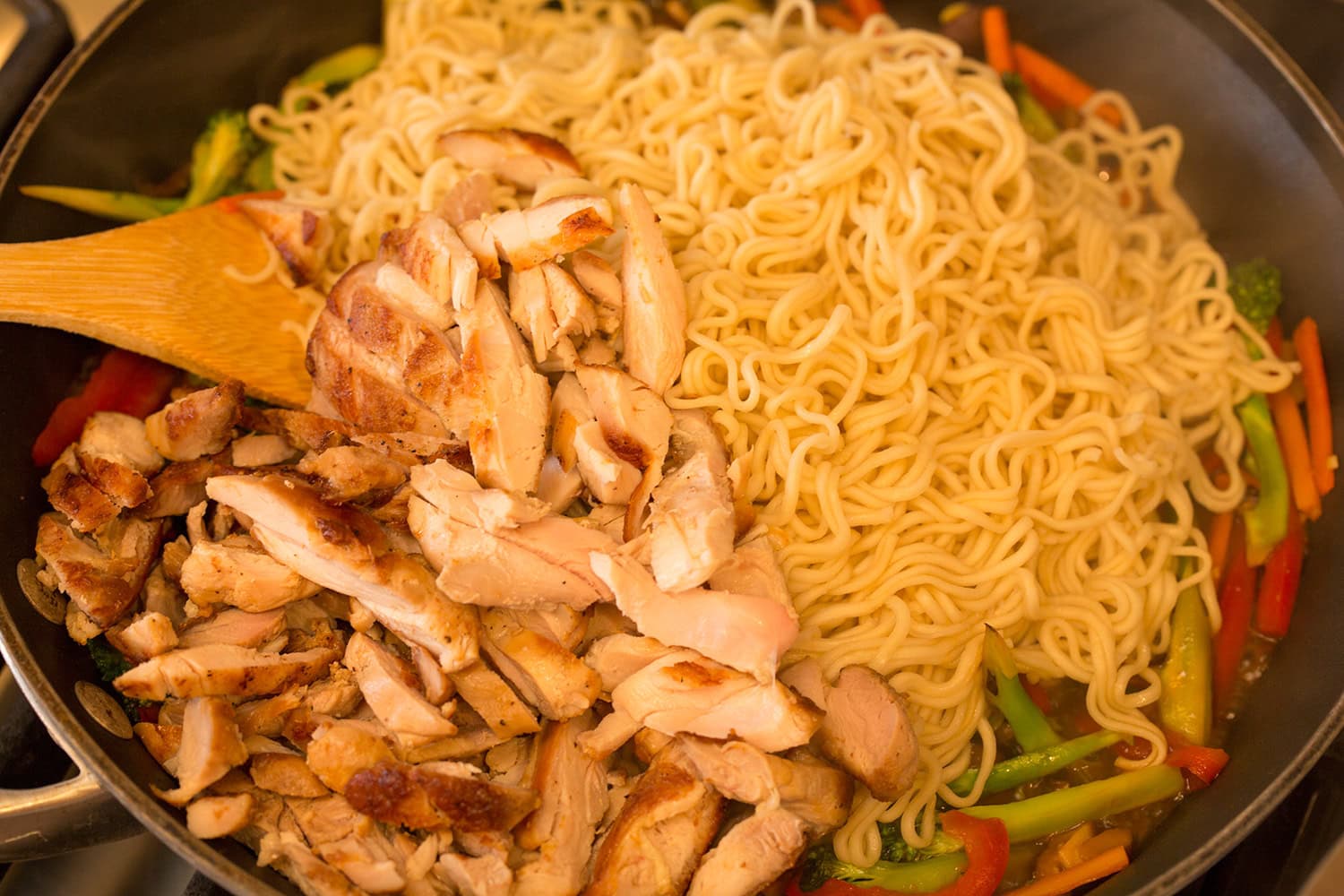 Ramen and cooked chicken added to stir fry.