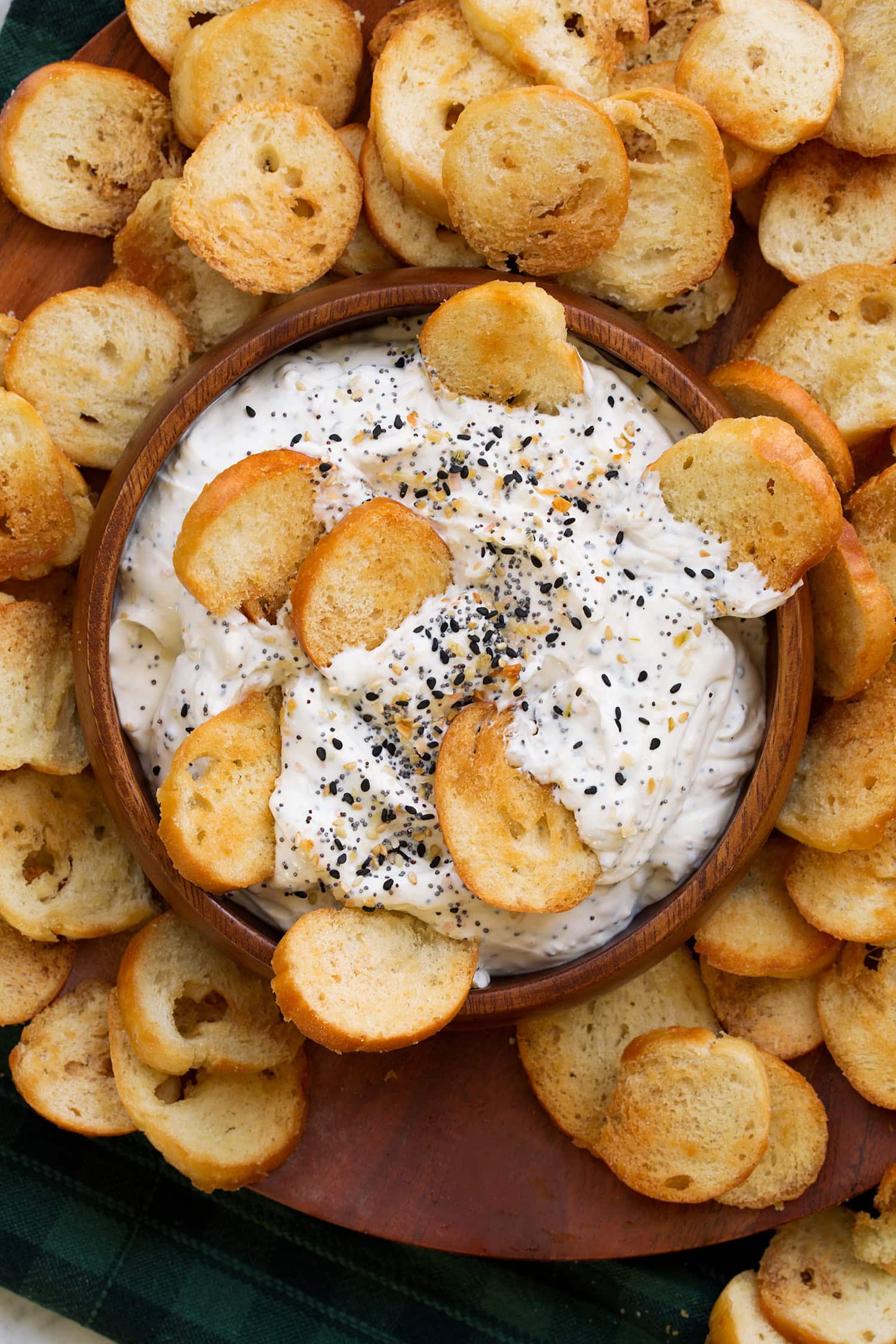 Close up overhead photo of bagel chips dunked in everything bagel dip.