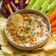 Platter with veggies, potato chips and french onion dip.