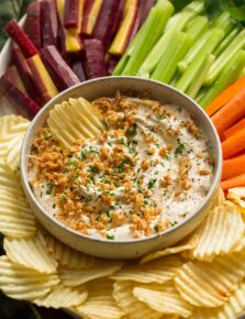 Platter with veggies, potato chips and french onion dip.
