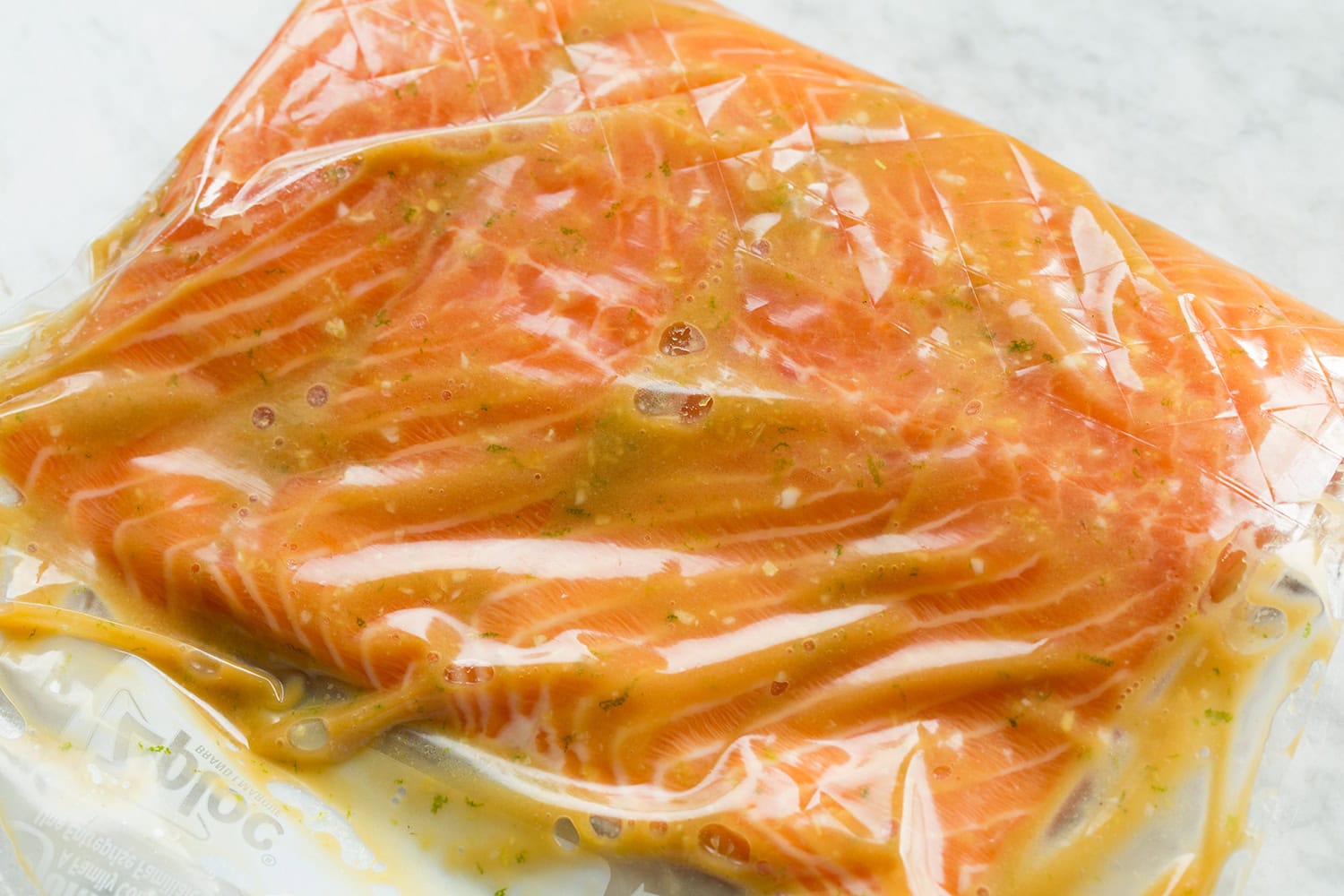 Miso marinade poured over salmon in a resealable bag.