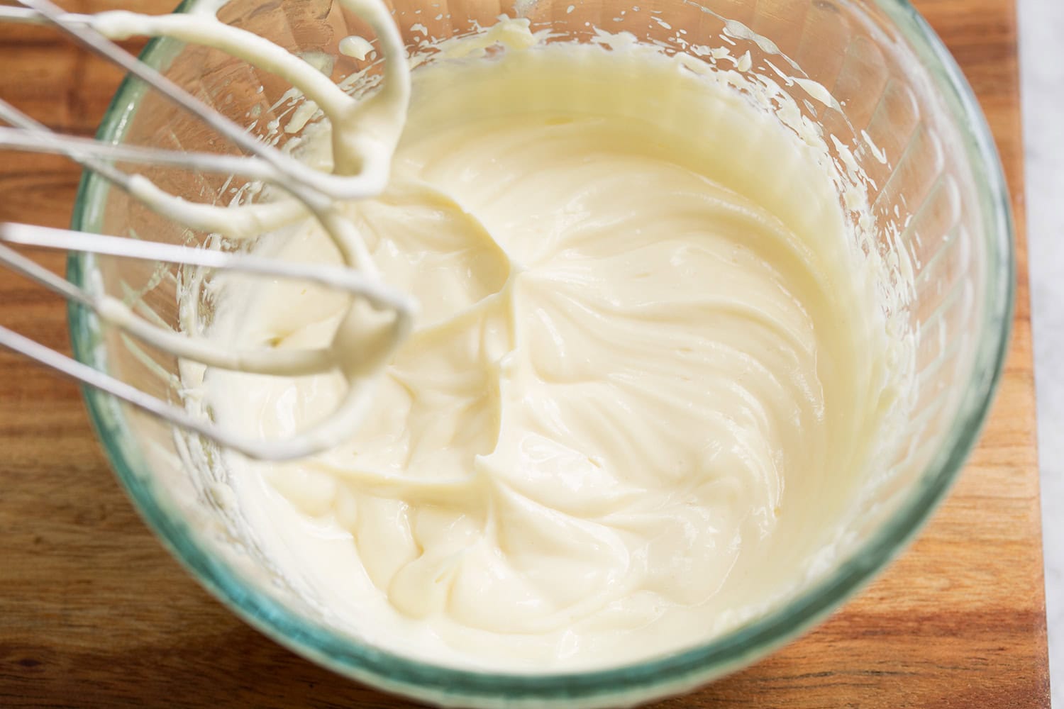Completed cream cheese honey icing in mixing bowl.