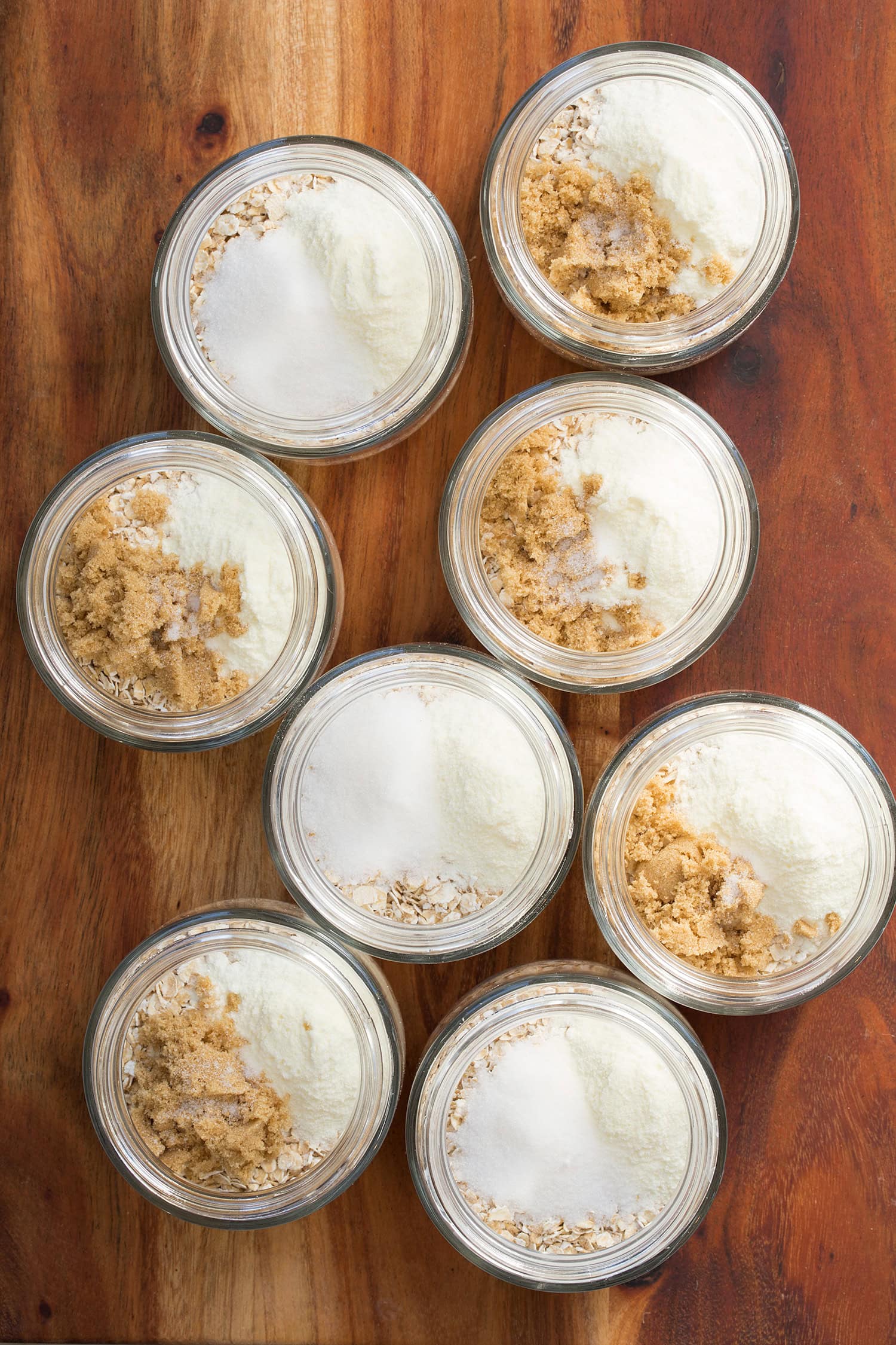 Dry milk, salt and sugar added to quick oats in jars.