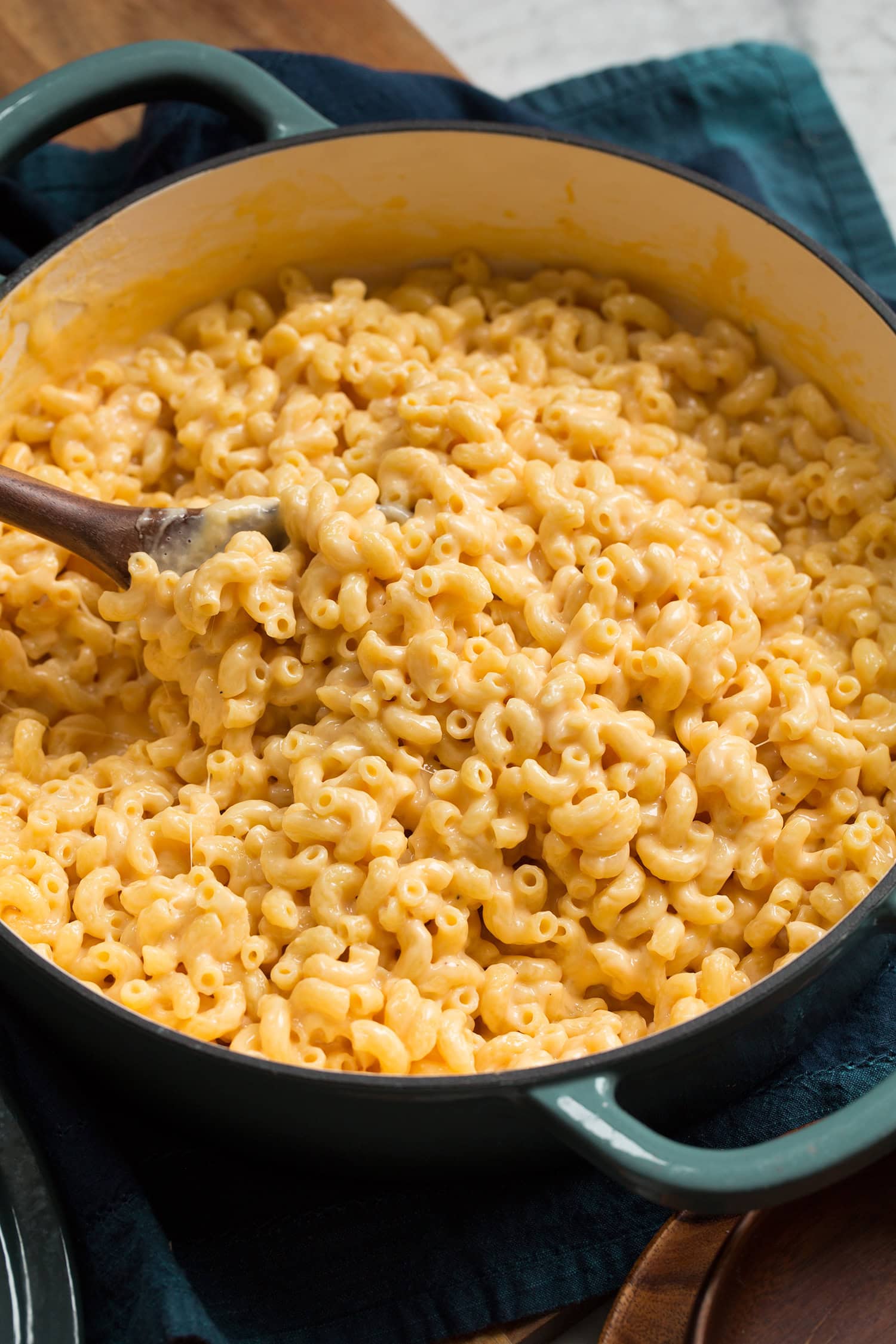 Mac and cheese shown in a braiser from the side.